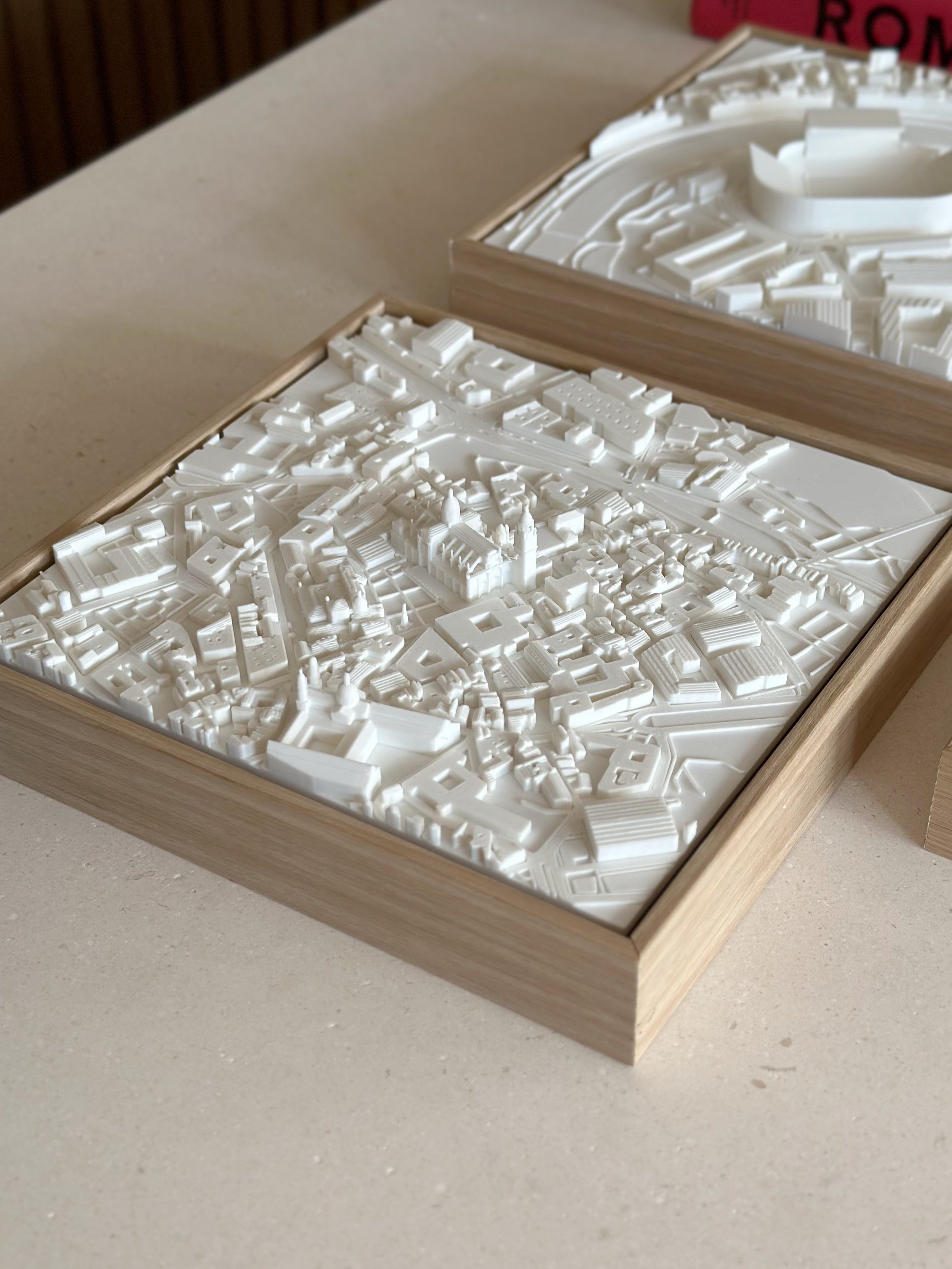 3D city map wall art in a wooden frame, detailed urban model decor on a table