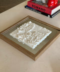 Framed 3D city map sculpture in white, modern decor on coffee table