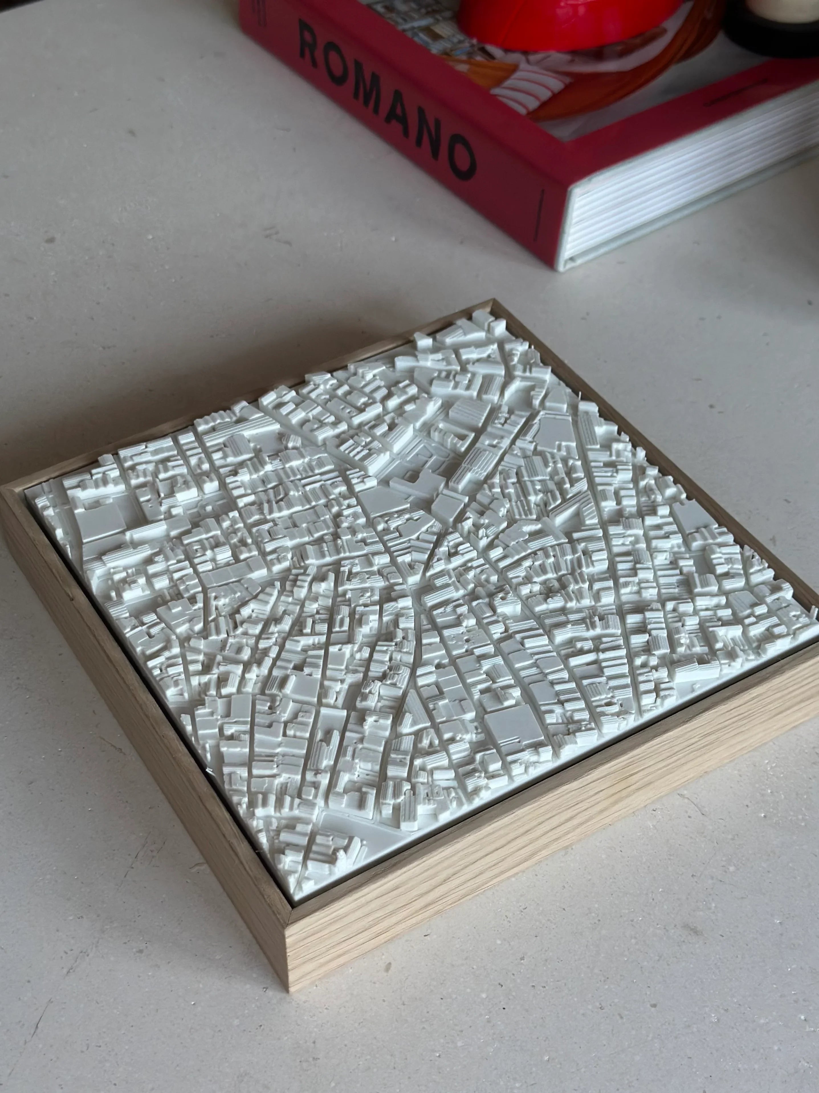 3D city map wall art in a wooden frame, modern decor on a tabletop setting