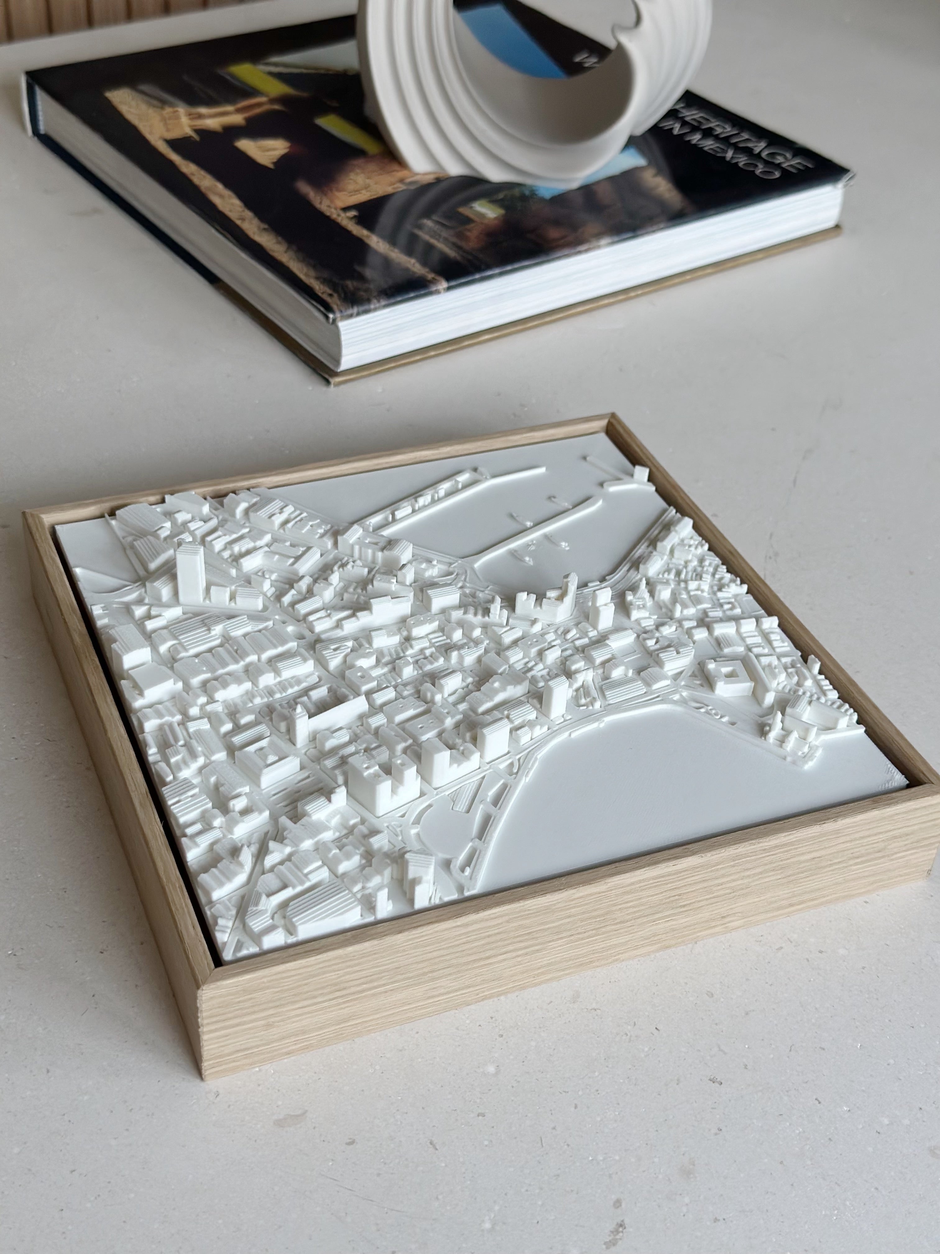 3D city map art in a wooden frame on a table, modern urban wall decor