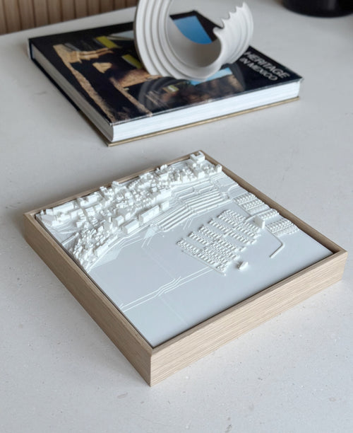 3D city map art in wooden frame on modern table, minimalist decor accent