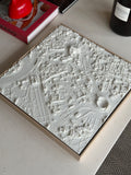3D city map wall art in white frame on a modern coffee table, stylish home decor