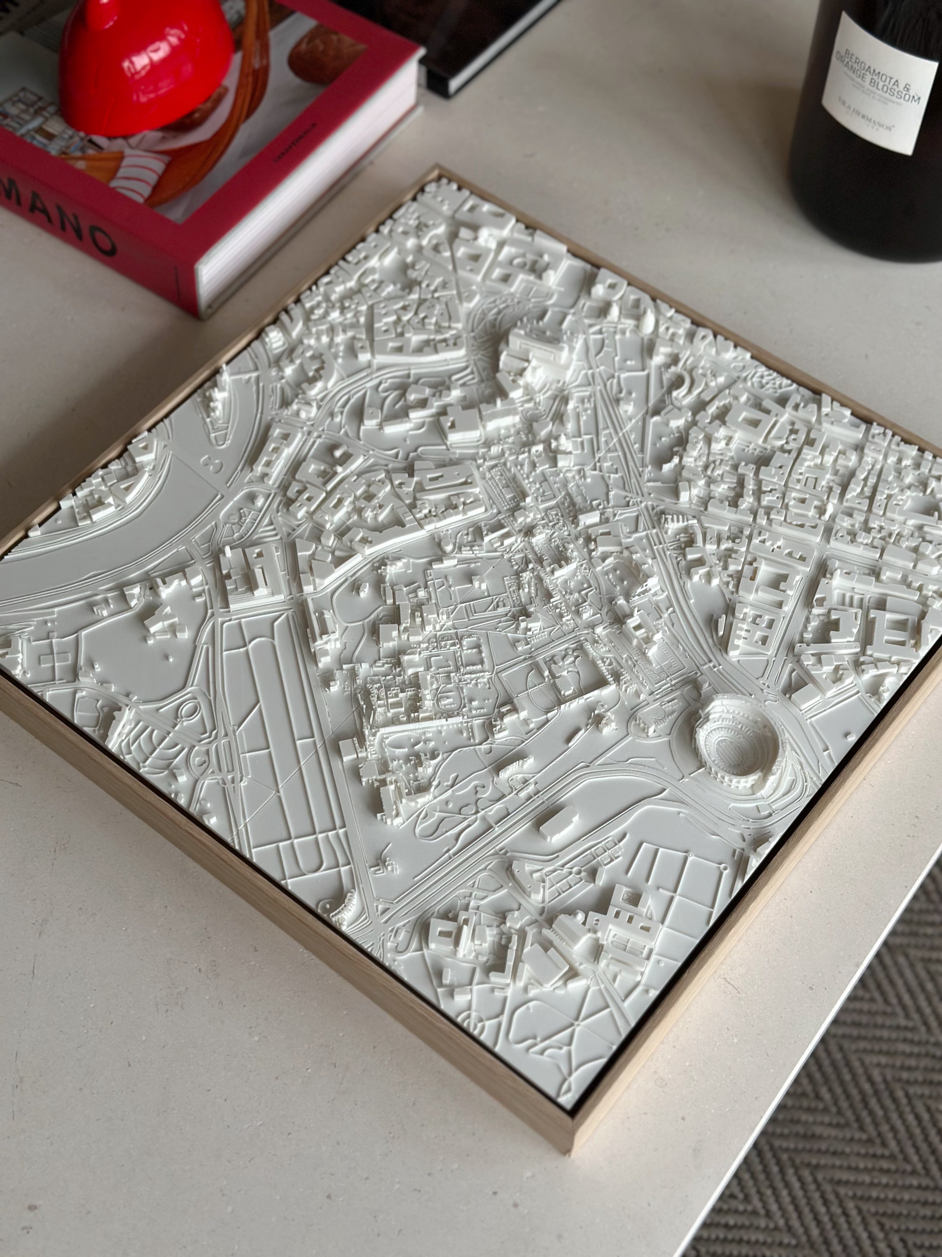 3D city map wall art in white frame on a modern coffee table, stylish home decor