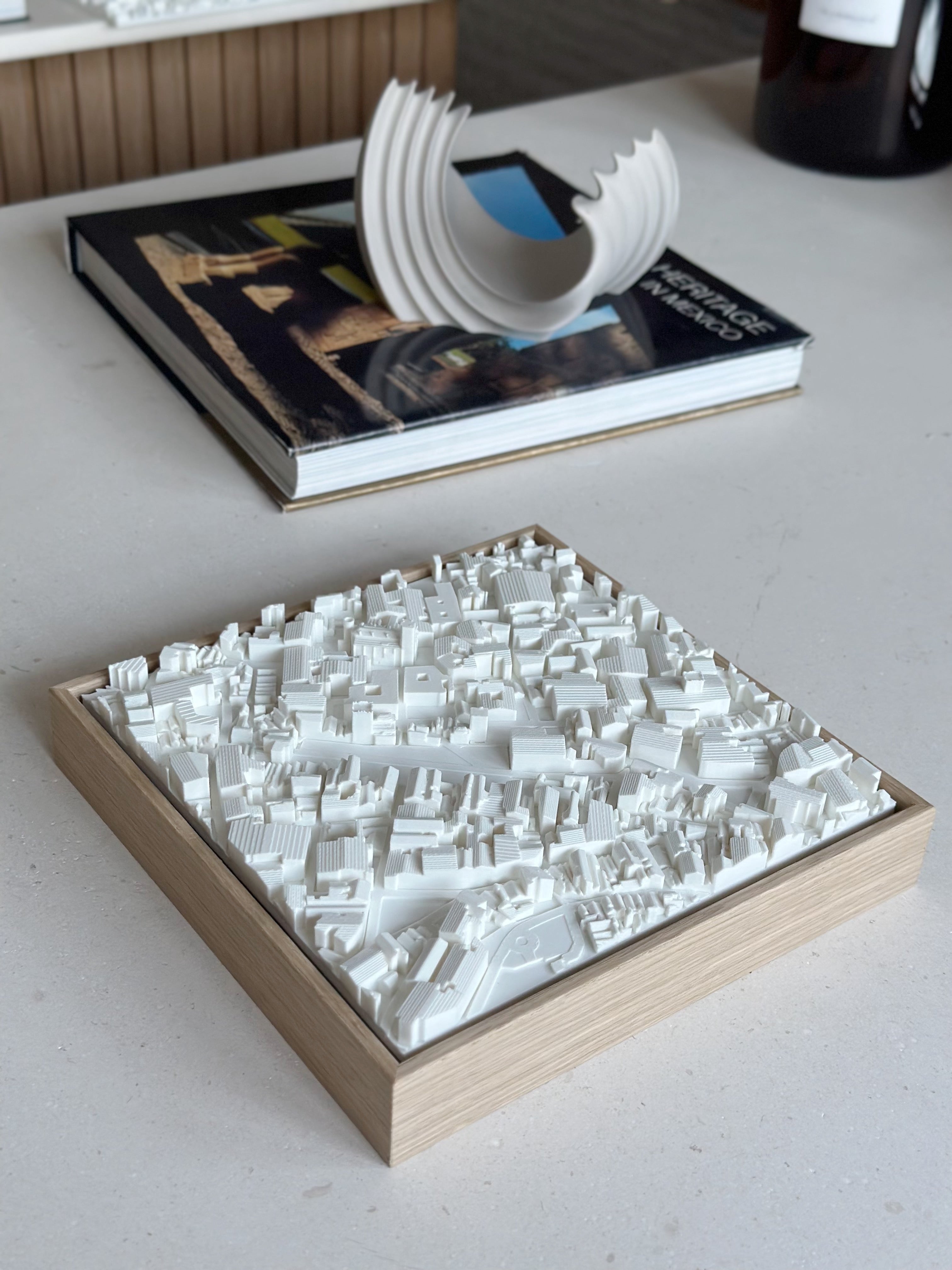 3D city map wall art in a wooden frame displayed on a modern table, decorative home decor