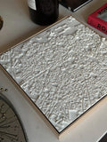 White 3D city map wall art on a table, detailed streets and buildings, modern decor piece.