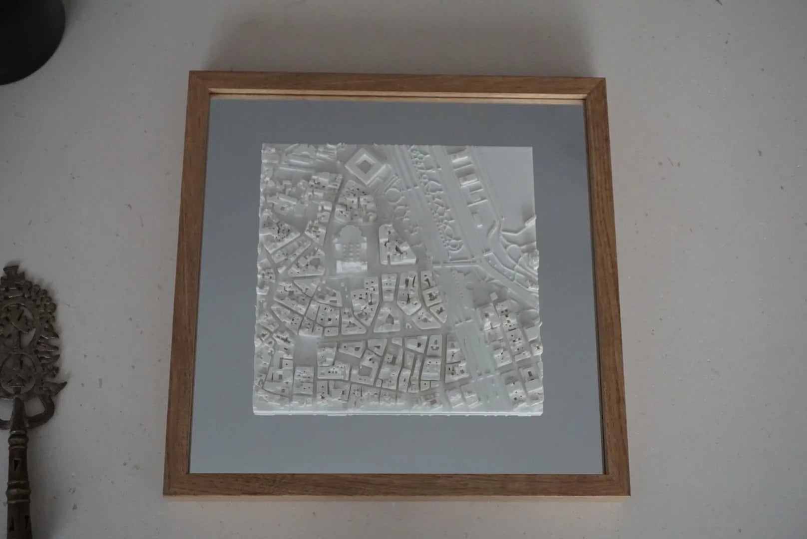 Framed 3D city map wall art with intricate white buildings and streets, modern home decor
