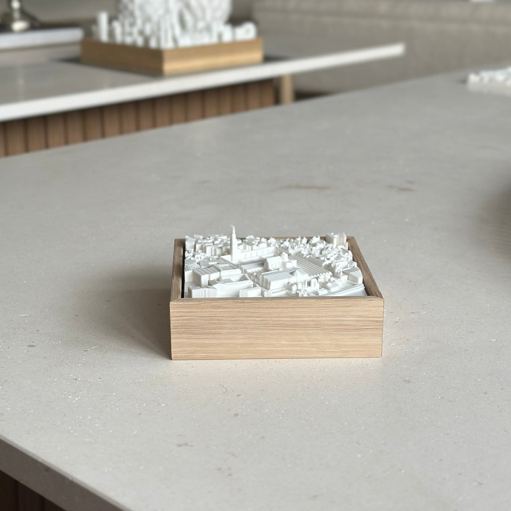 3D city map art in wooden frame on modern table, minimalist urban decor