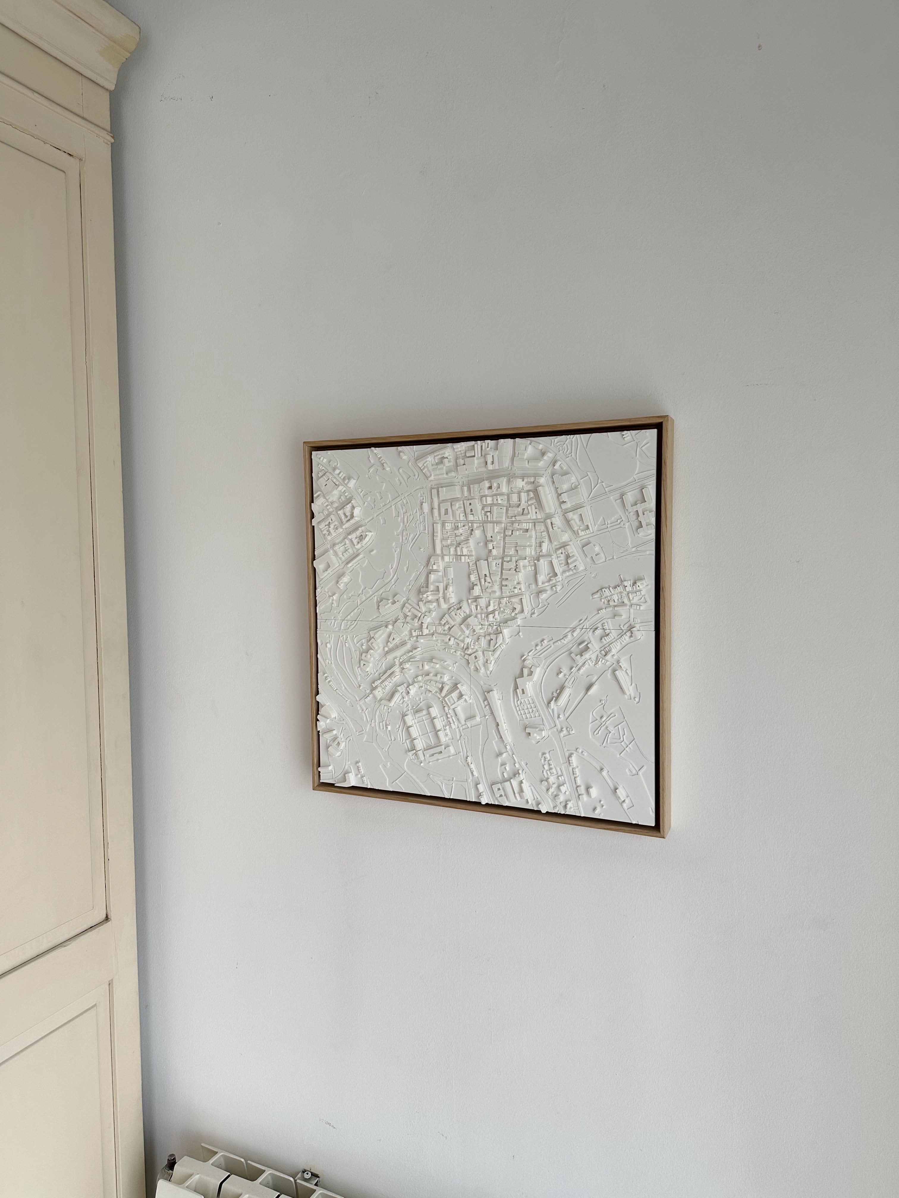 3D city map wall art in white frame, modern home decor on light wall