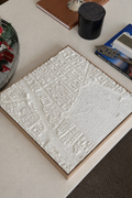 3D city map wall art with detailed streets and buildings on a modern coffee table
