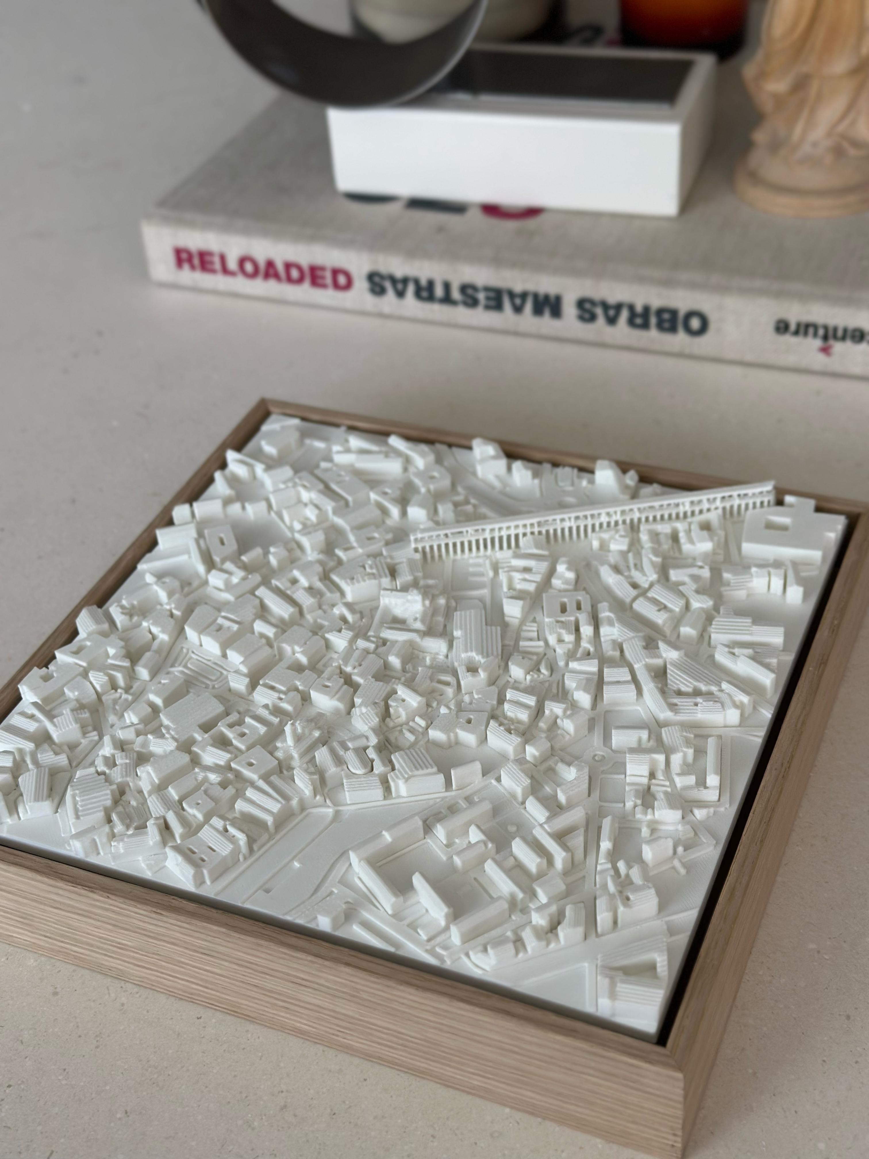 3D city map wall art in a wooden frame, detailed white architectural model