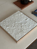 3D city map wall art in white on a coffee table, modern home decor accent piece