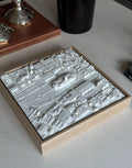 3D city map wall art in a wooden frame on a modern table, minimalist urban decor