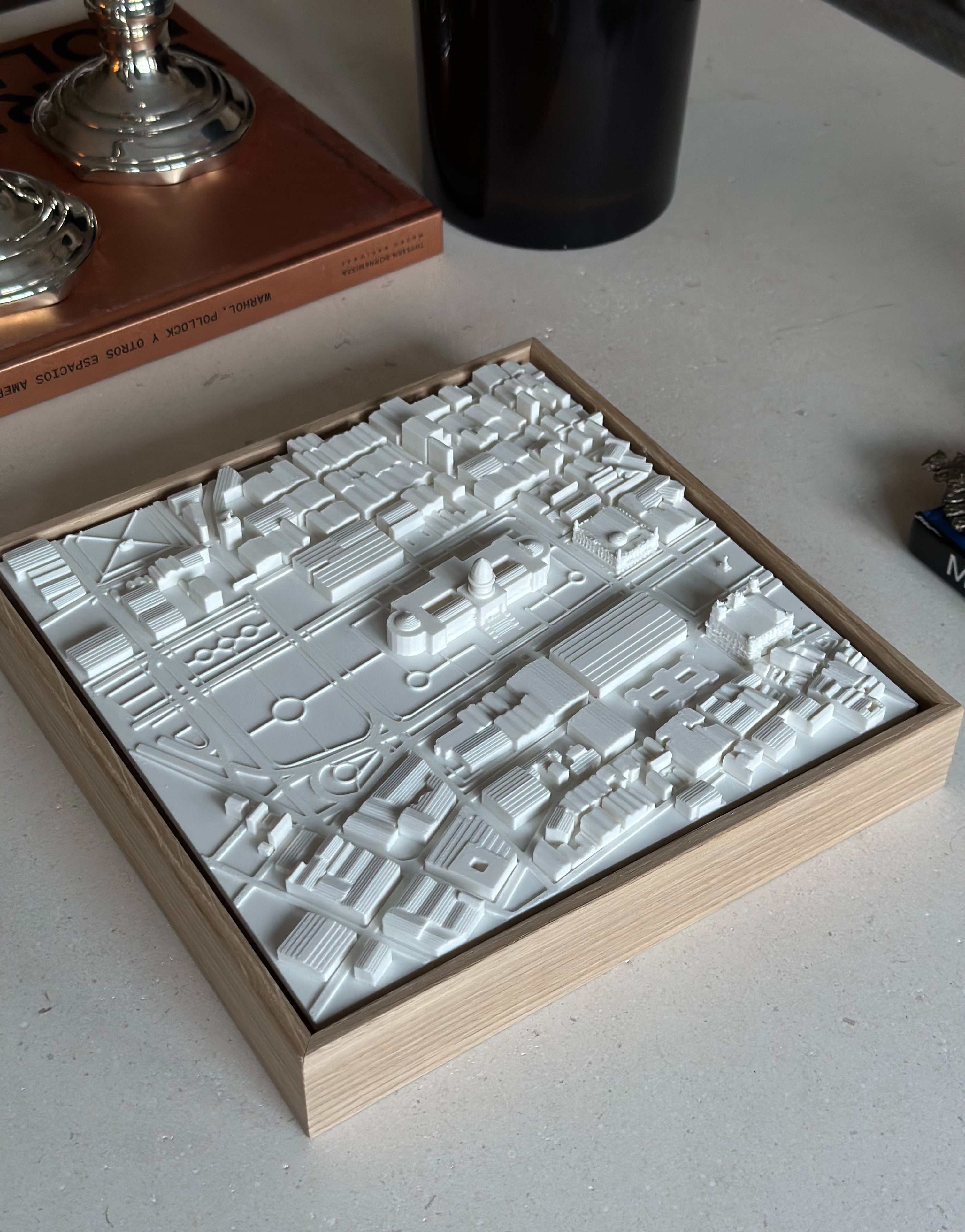 3D city map wall art in a wooden frame on a modern table, minimalist urban decor