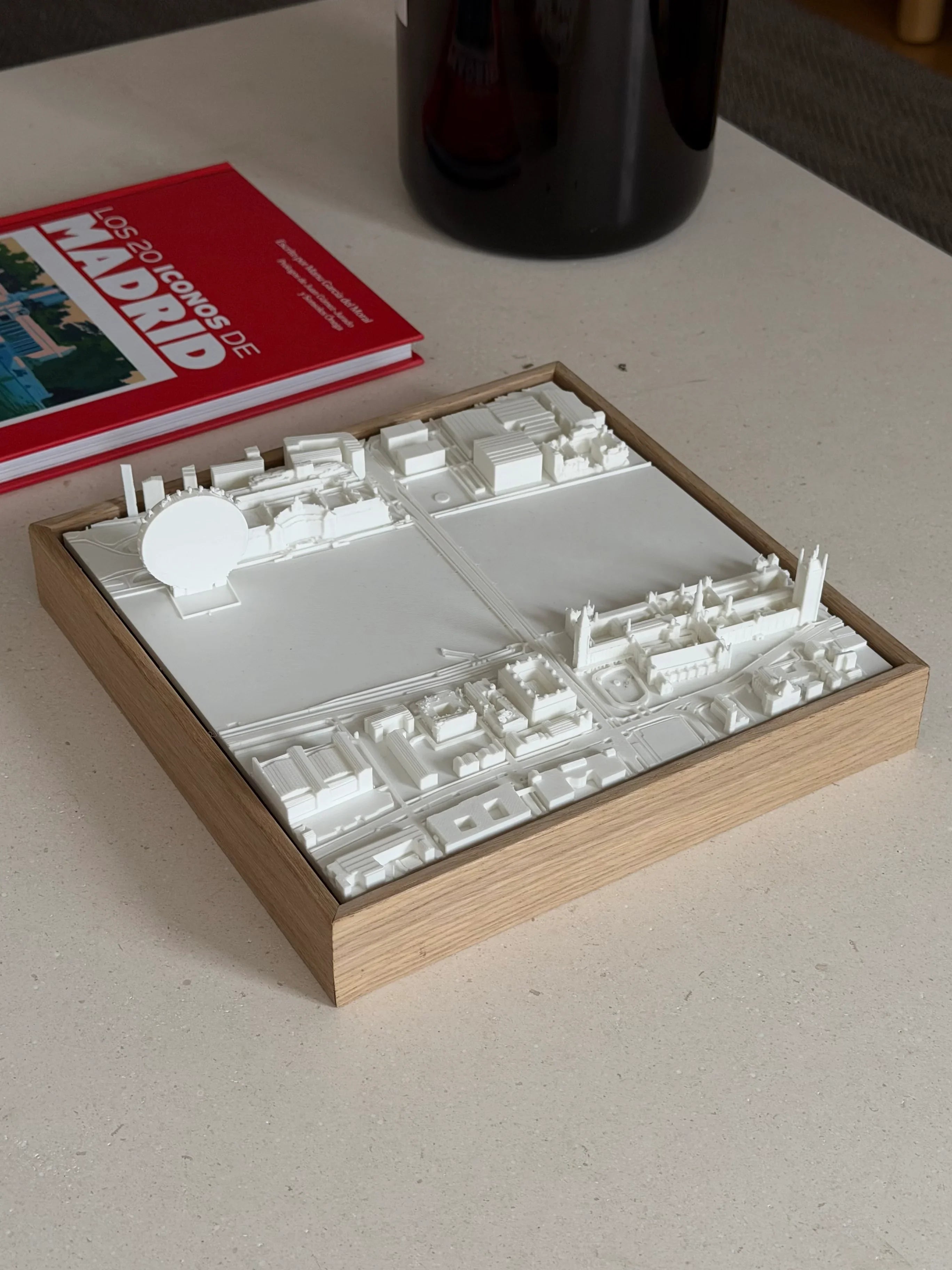 3D city map of Madrid in a wooden frame on a table, decorative travel gift
