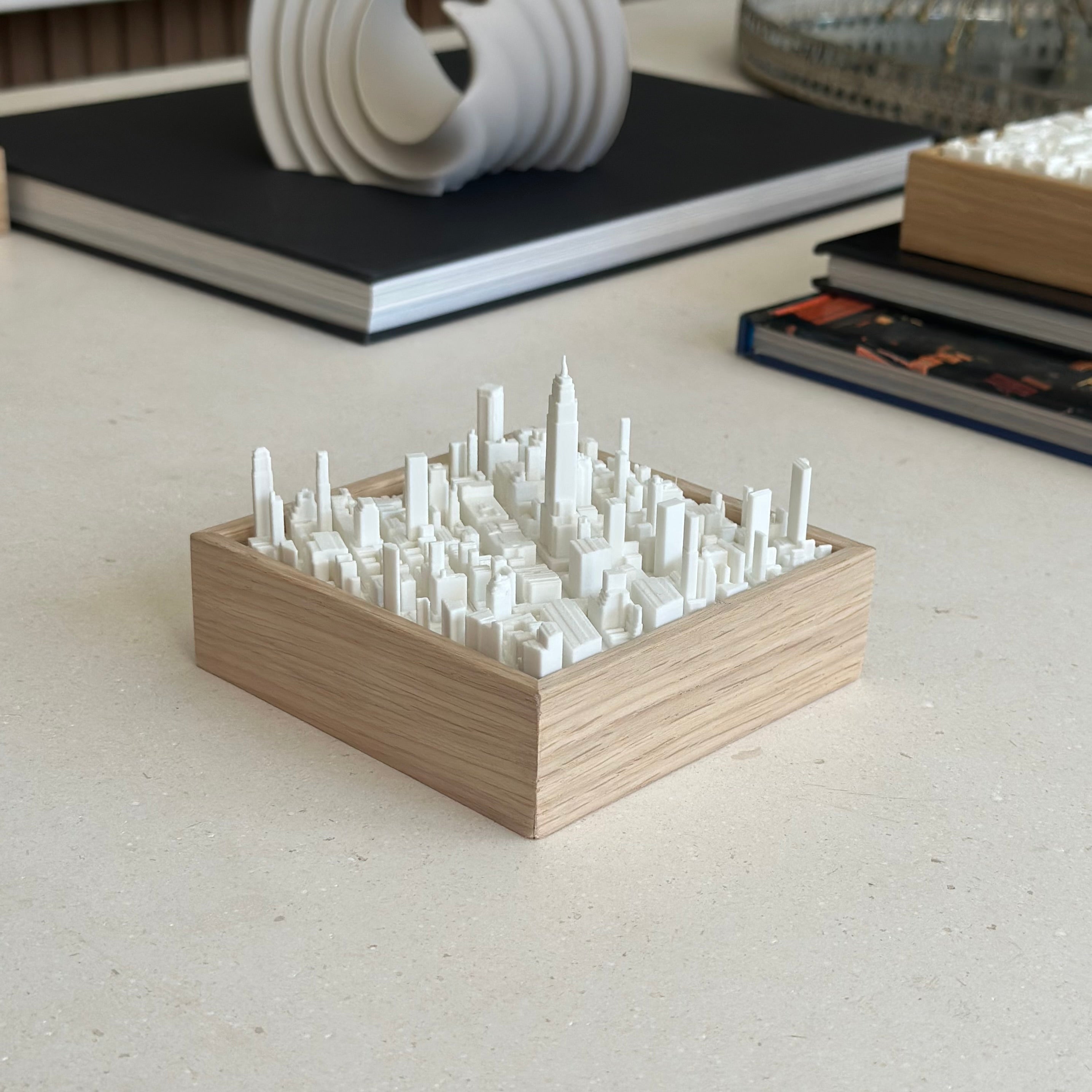 3D city map art in wood frame, minimalist urban decor on modern desk