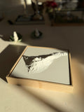 Framed 3D city map artwork with detailed white topography on a light background