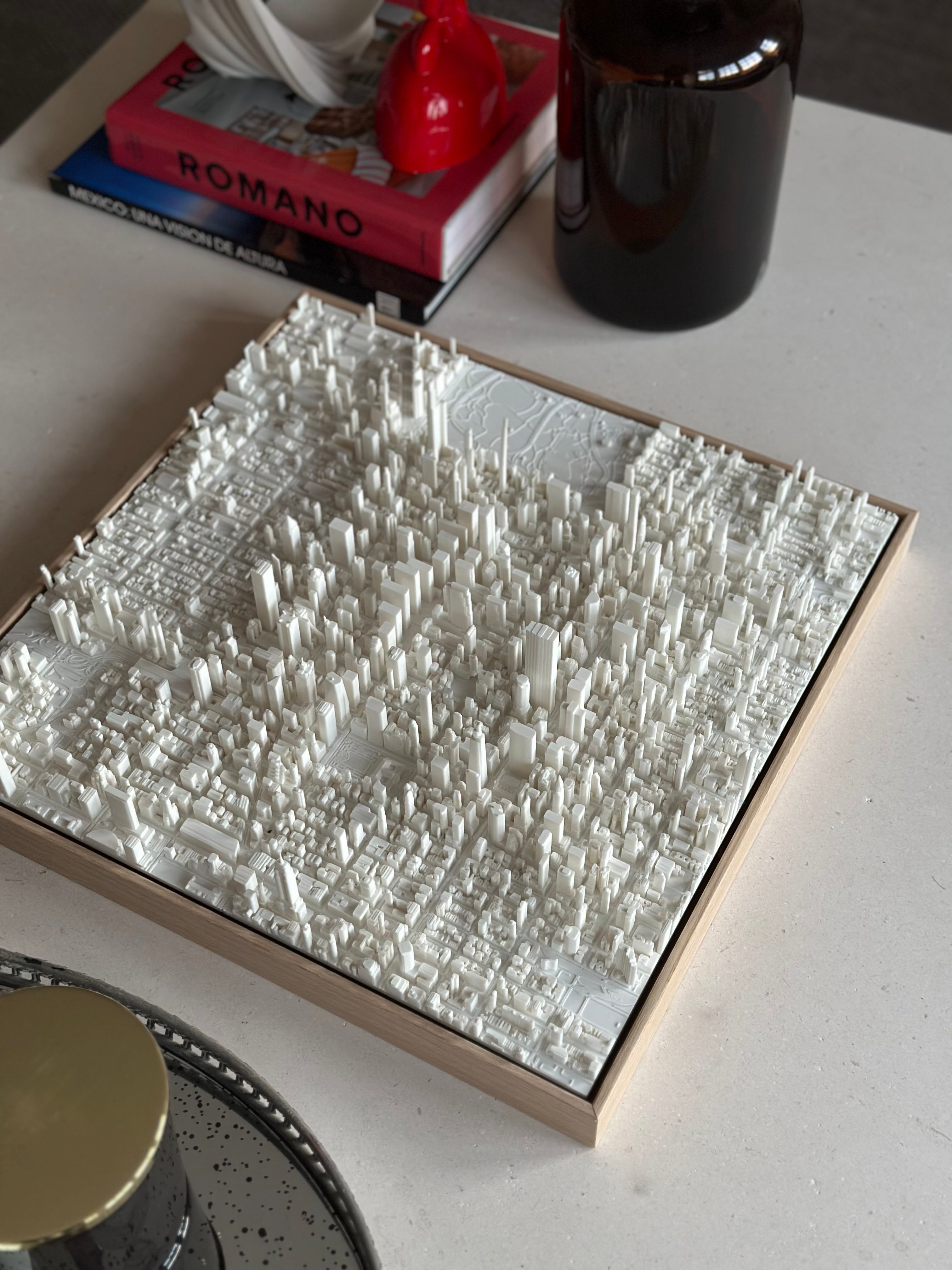 3D city map art piece with white buildings on a modern coffee table, stylish home decor