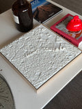 3D city map wall art in white on a modern coffee table with books and decor