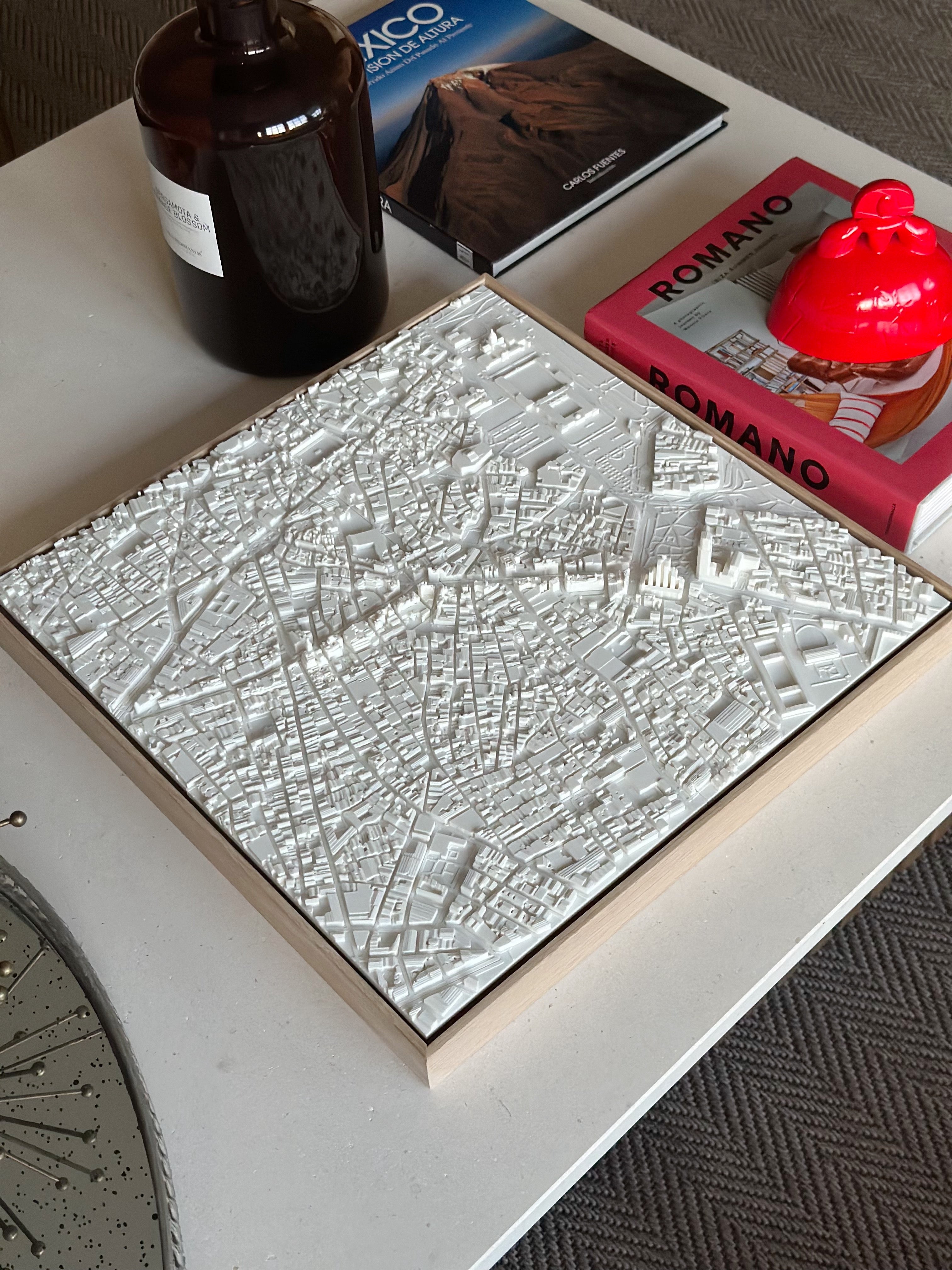 3D city map wall art in white on a modern coffee table with books and decor