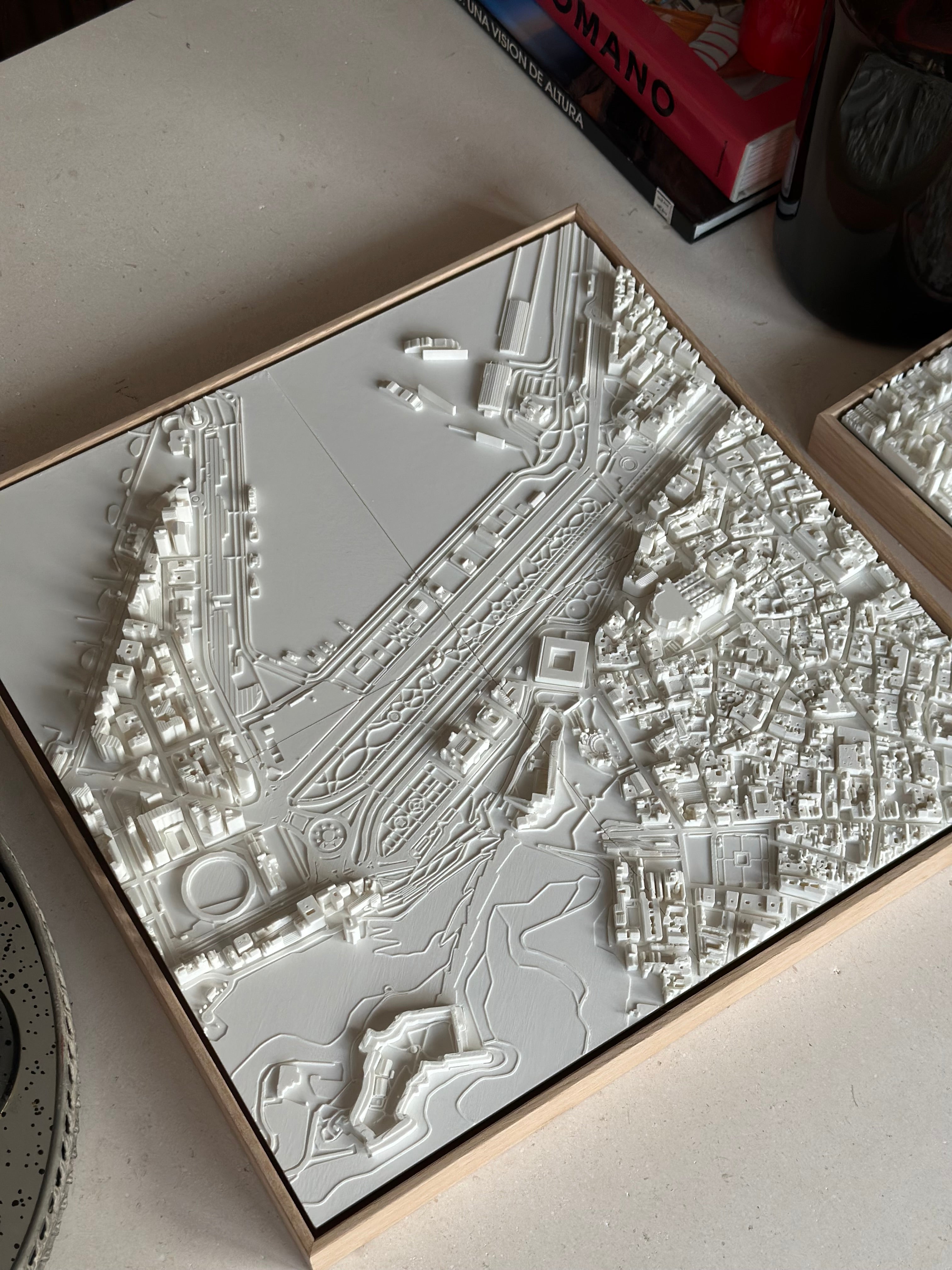 White 3D city map wall art in a wooden frame, architectural decor model on table