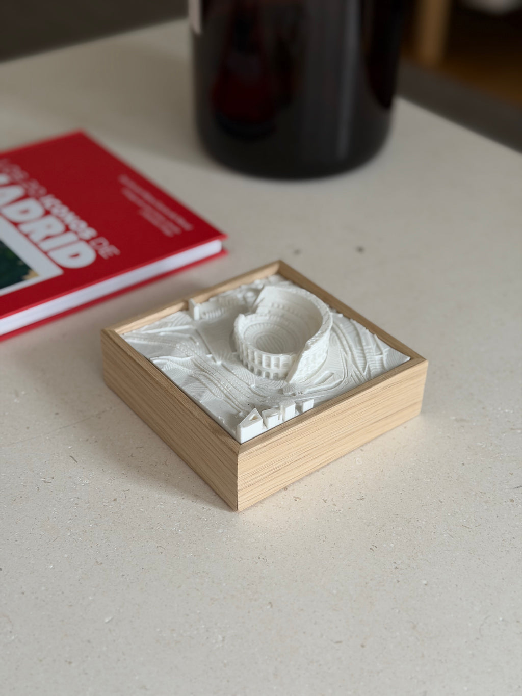 3D city map art of Madrid in a wooden frame on a light tabletop