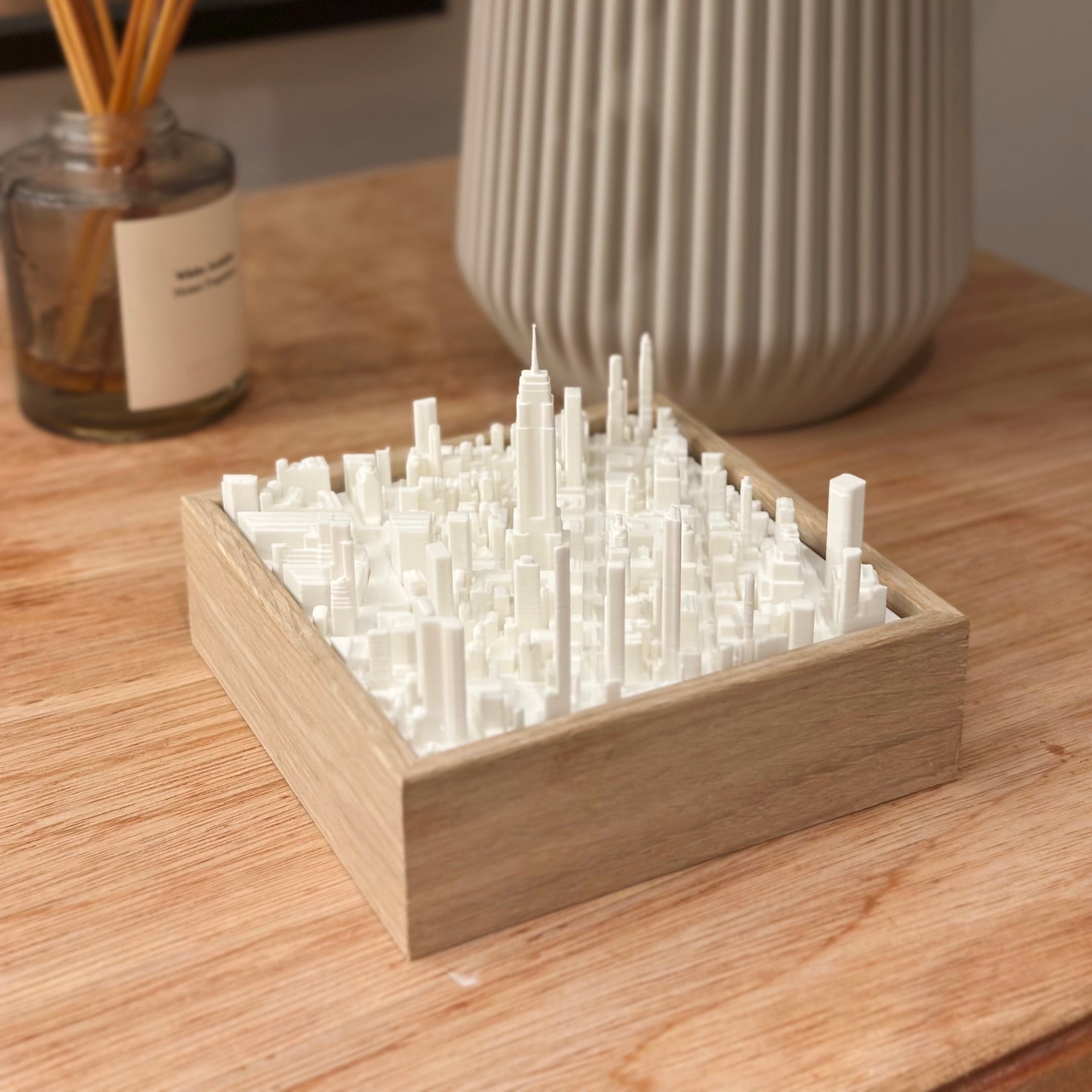 3D city map model in a wooden frame on a wooden table, modern home decor