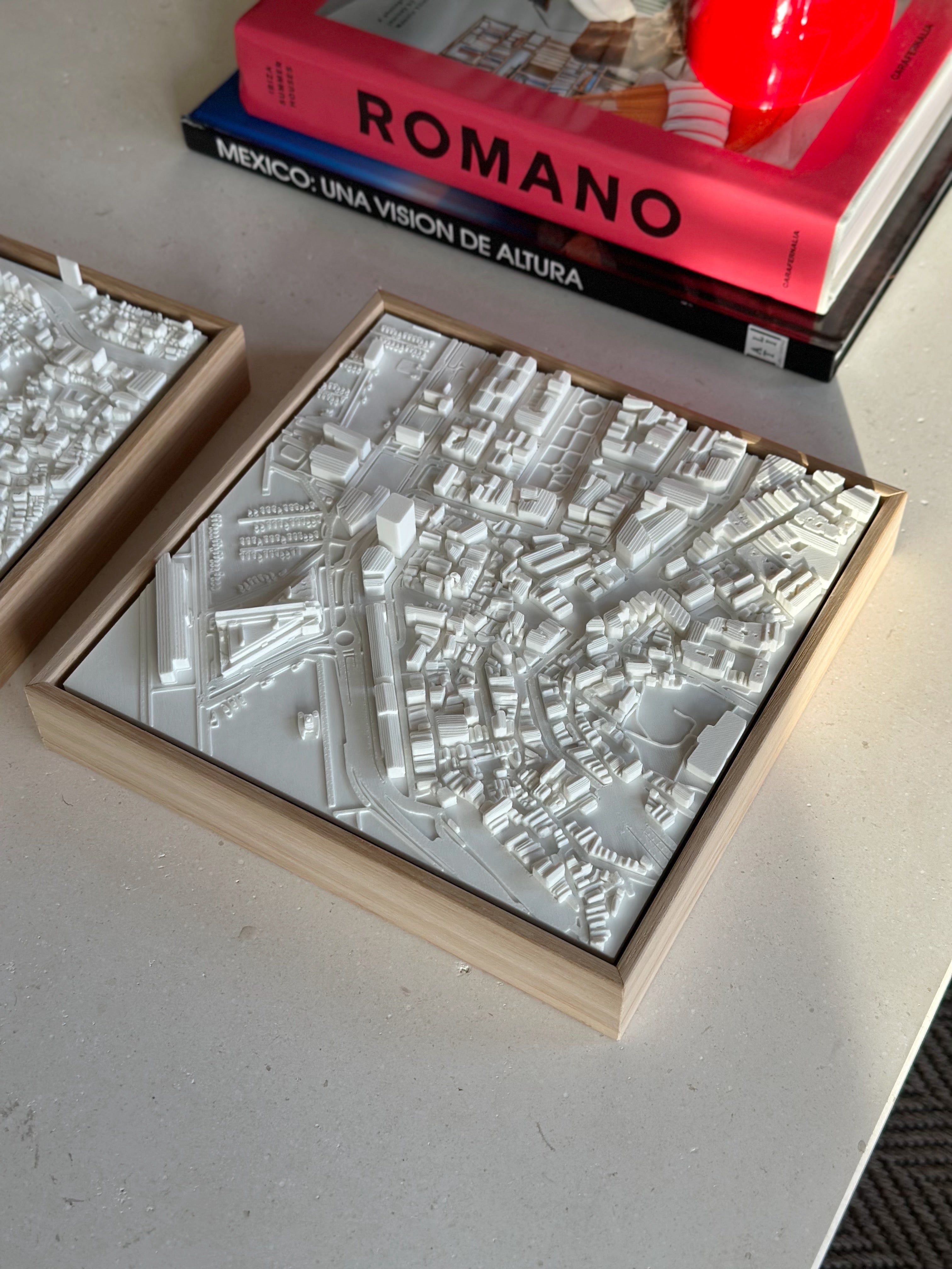 3D city map wall art in white frame on table, modern urban decor piece