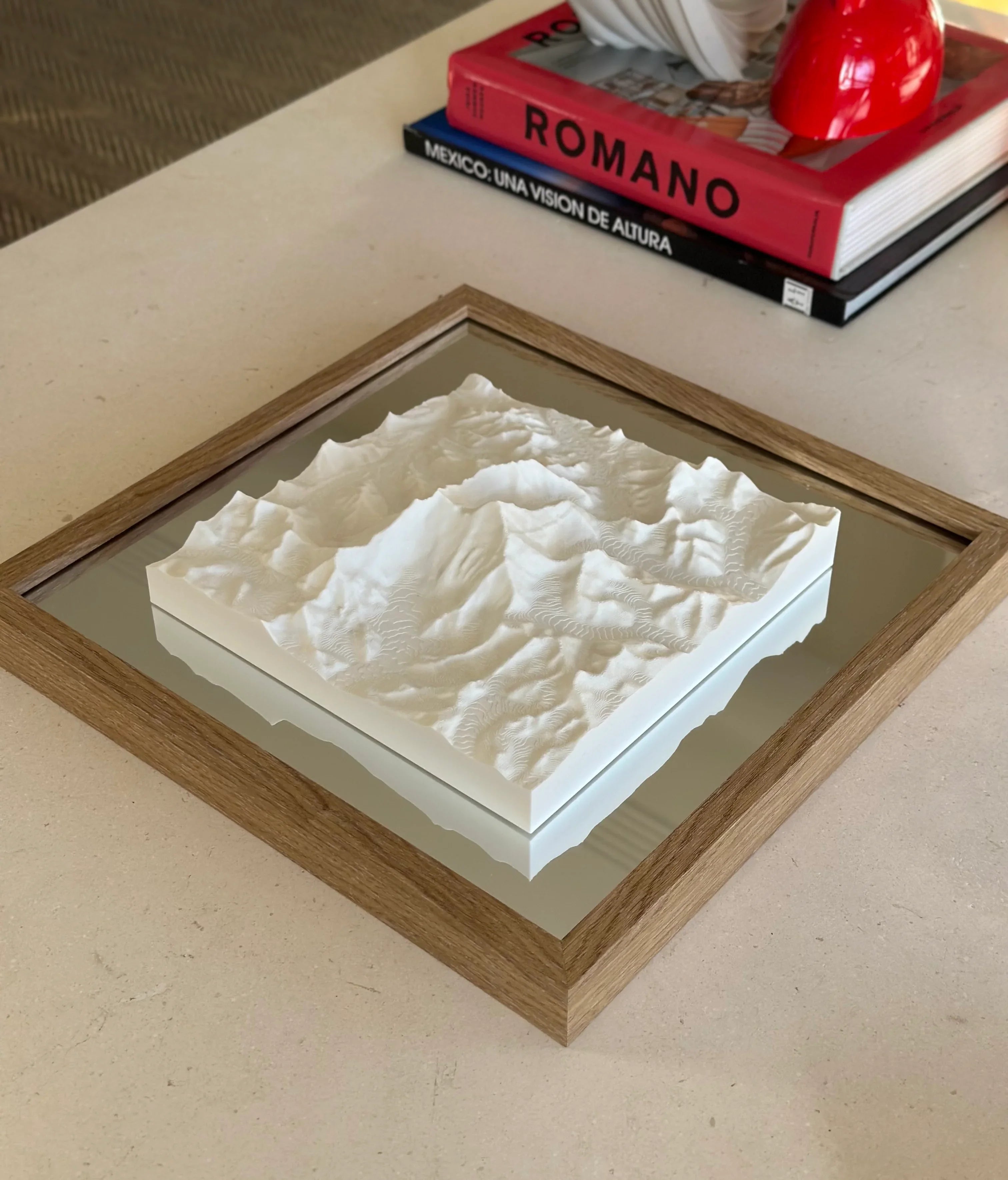 Framed 3D city map artwork with white topography on a table, modern decor style