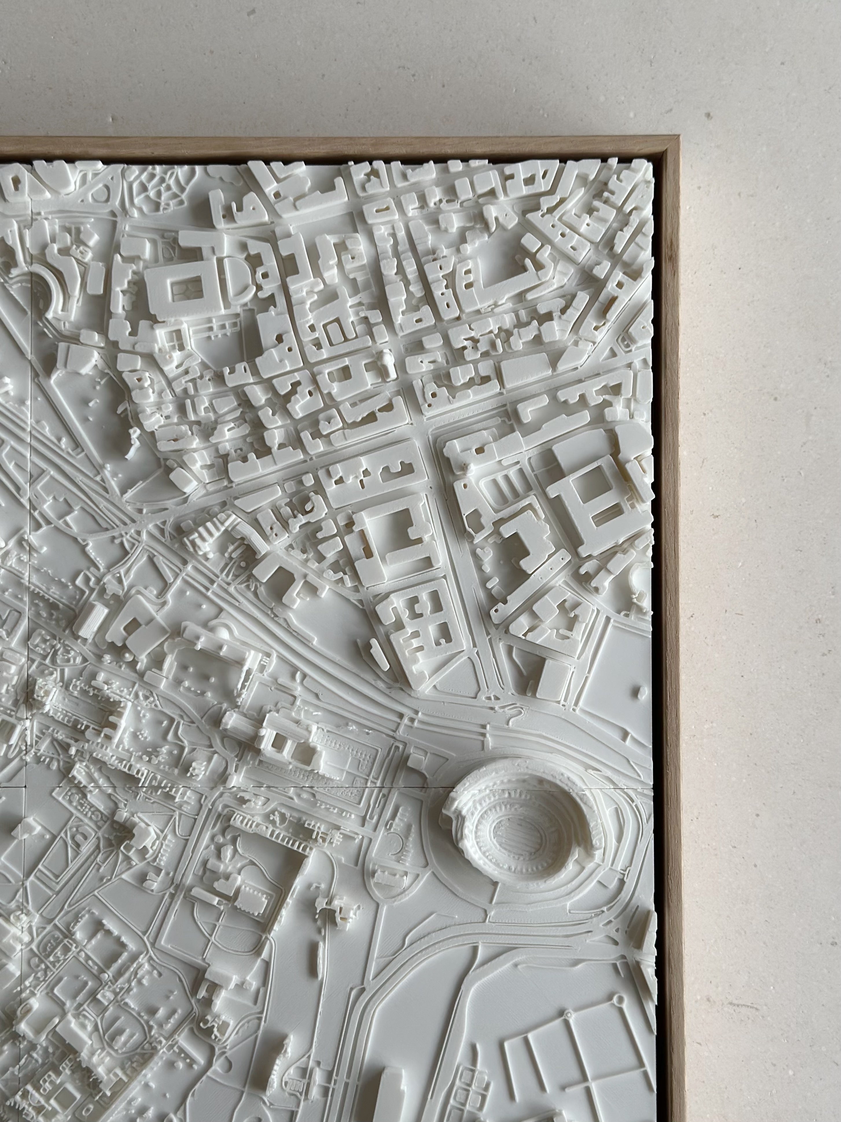 3D city map wall art with detailed white architectural structures and urban layout