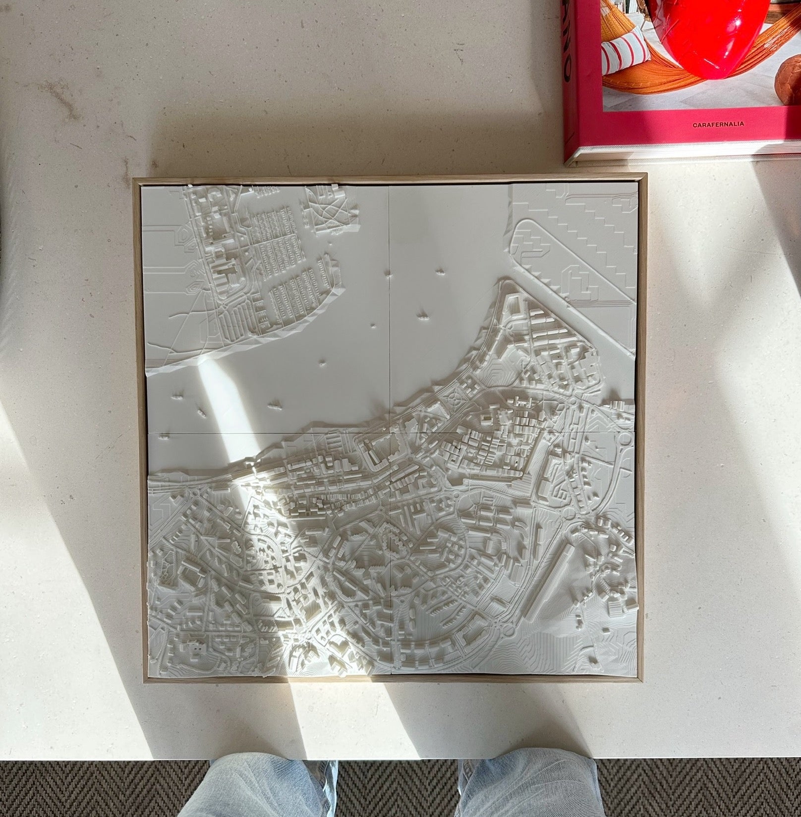3D city map wall art in white relief, modern urban decorative piece on a table