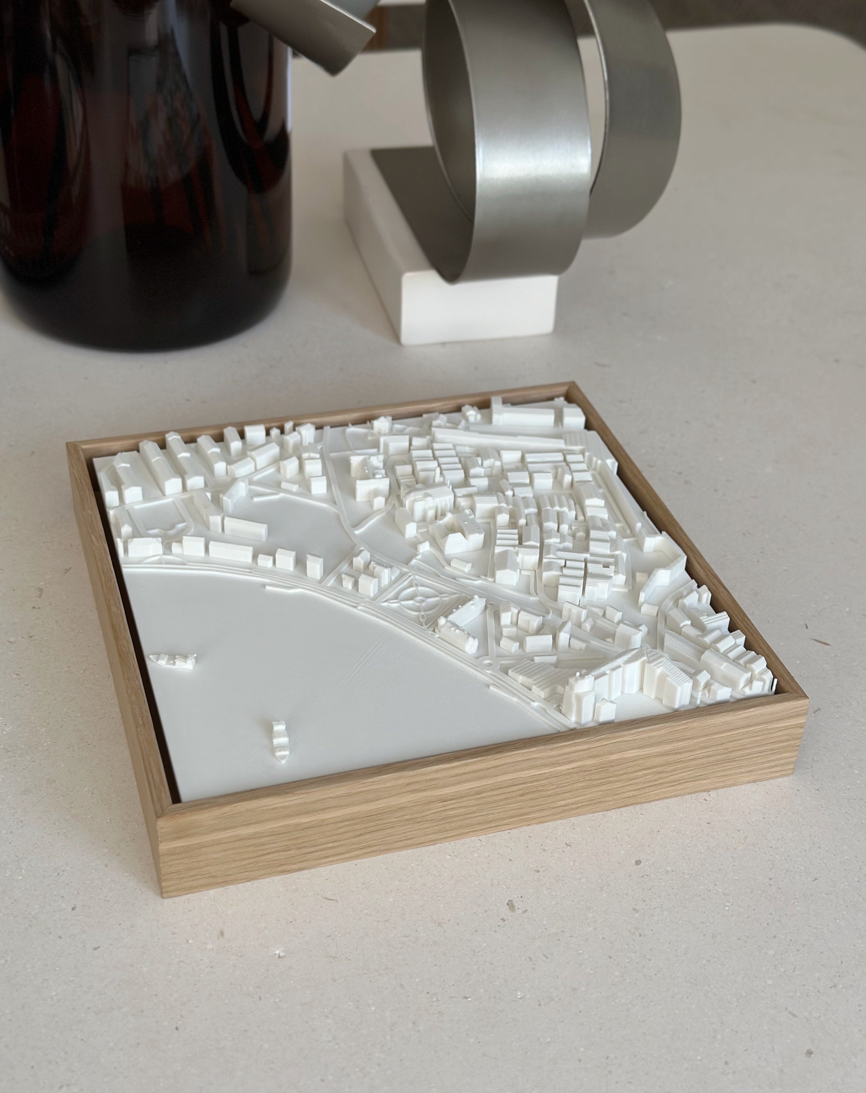 3D city map art in wooden frame, modern minimalist decor on a light tabletop