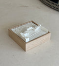 3D city map art in a wooden frame on a light stone surface, minimalist home decor