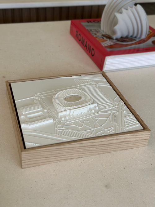 3D city map wall art in a wooden frame on a tabletop, modern urban decor accent.