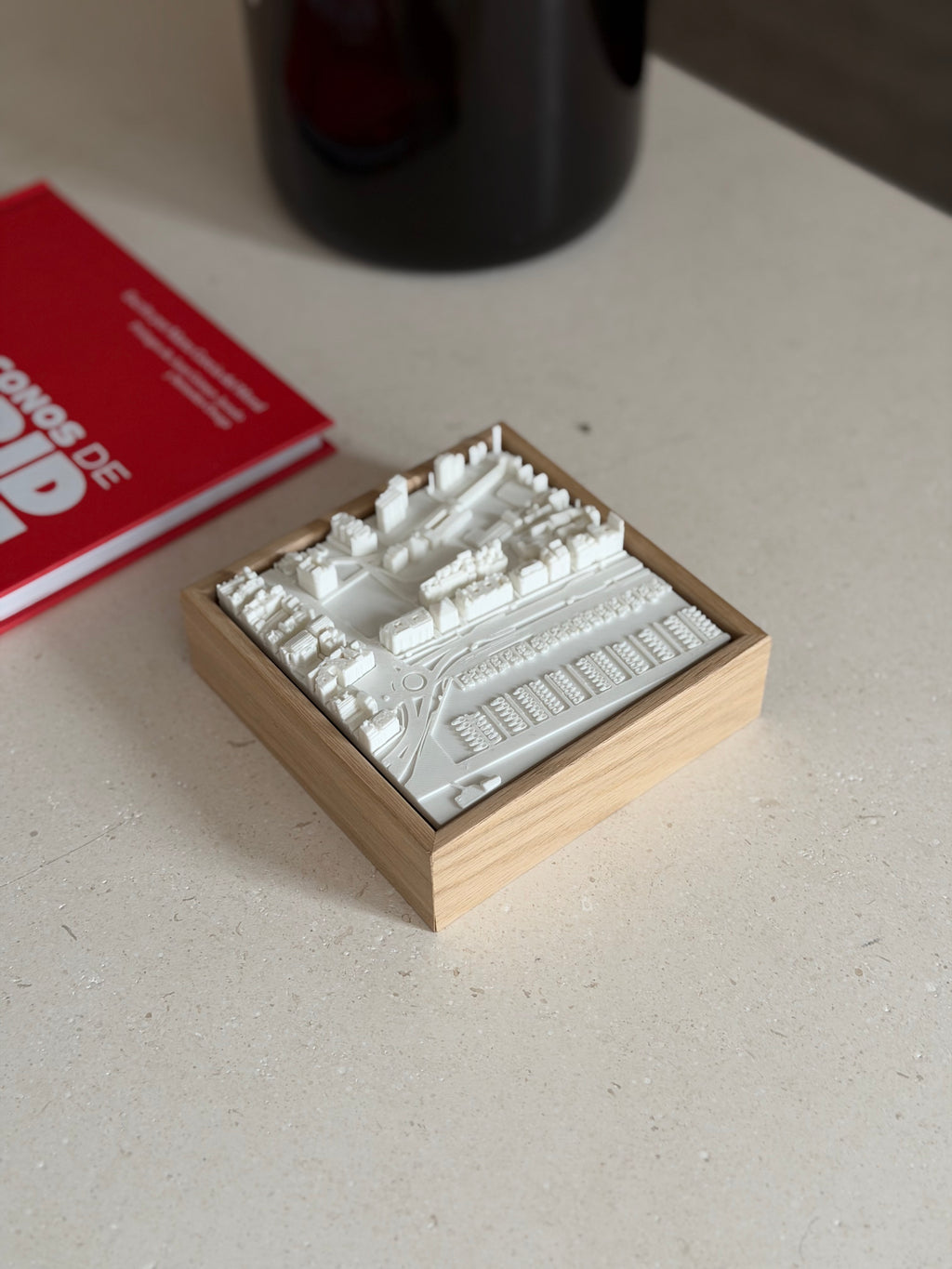 3D city map wall art in a wooden frame on a beige table, modern urban decor