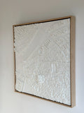 Framed white 3D city map wall art with detailed urban buildings and streets