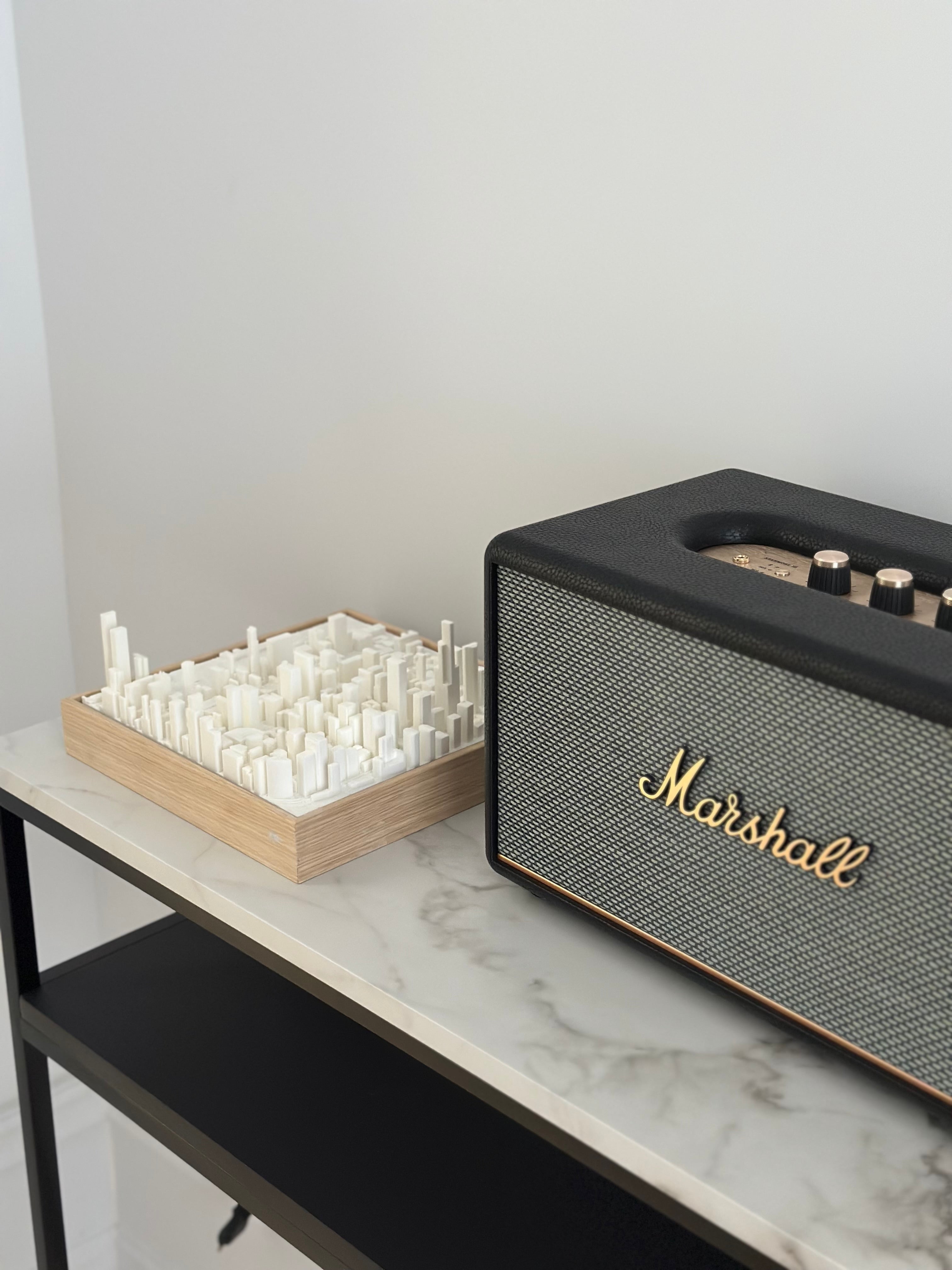 Modern decor with a 3D city map artwork and Marshall speaker on a marble shelf
