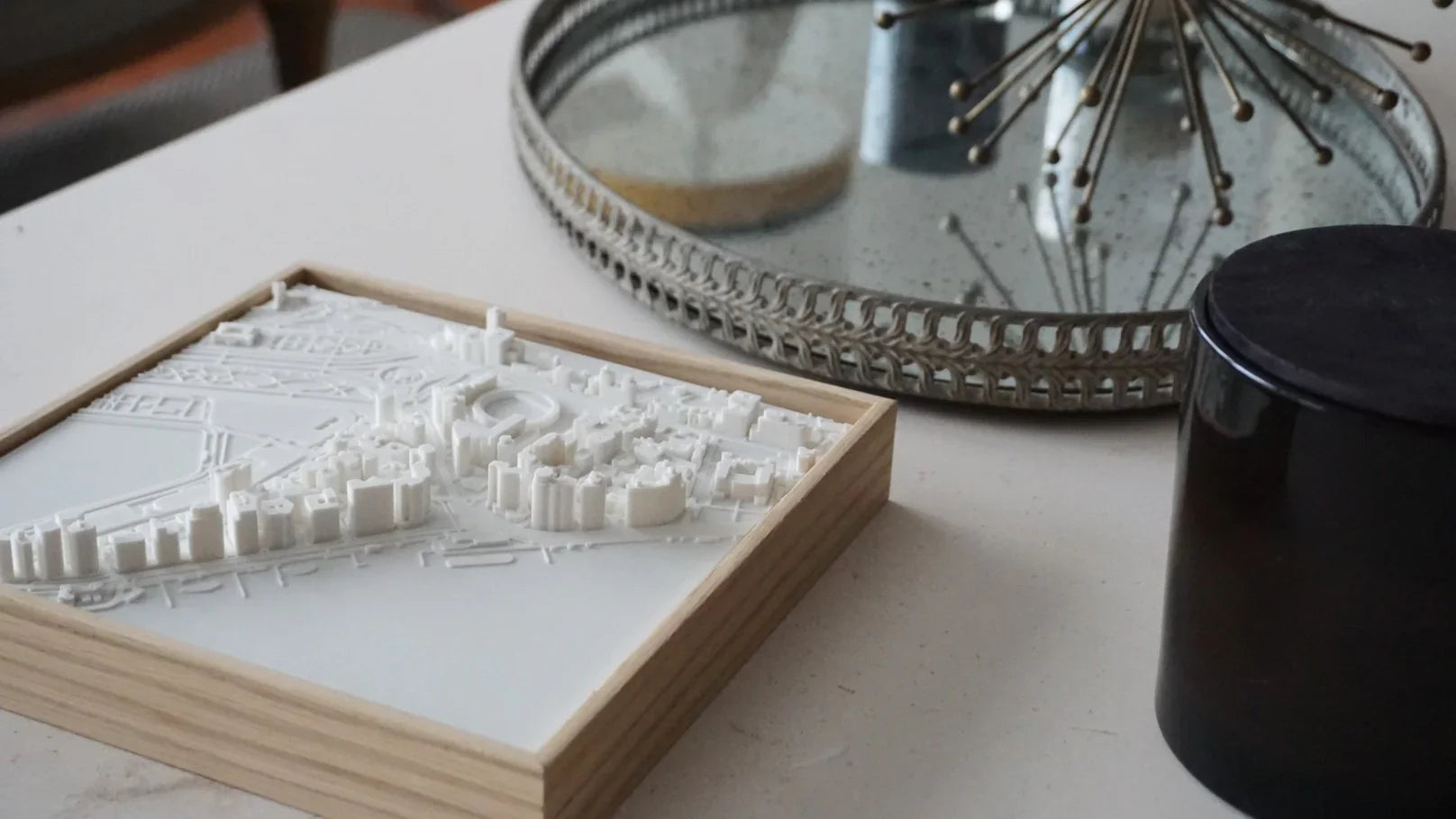 3D city map wall art in a wooden frame on a modern decorative table
