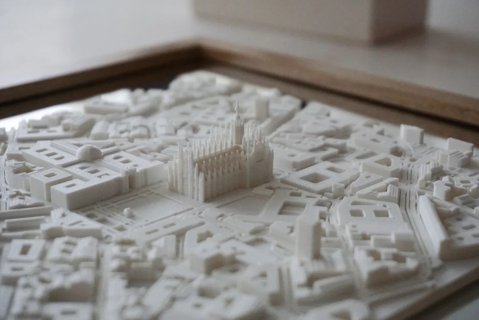3D city map wall art with raised architectural landmarks in white, detailed decorative decor