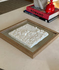 Framed 3D city map wall art in white on a wooden table, modern home decor accent