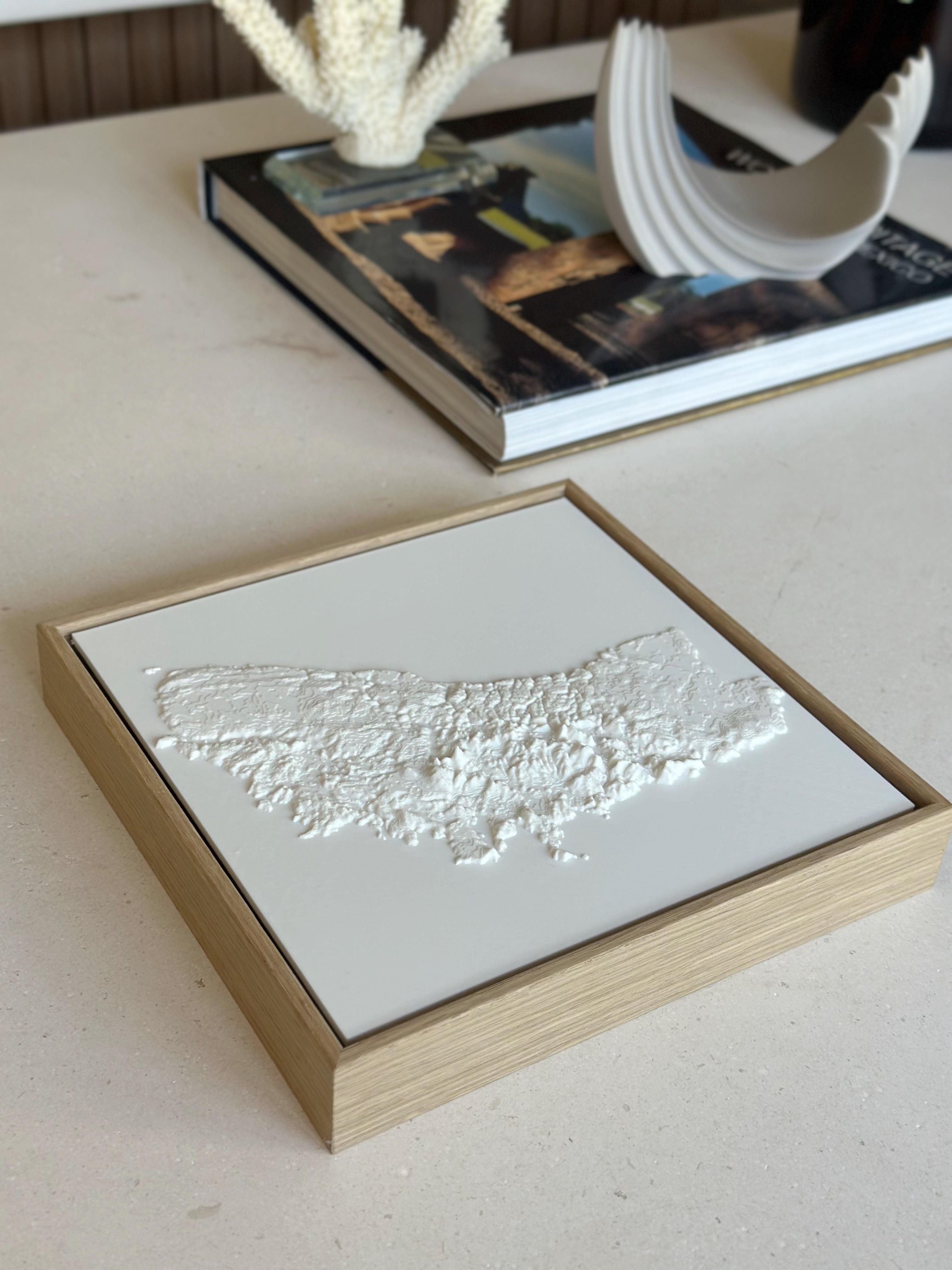 Framed 3D city map wall art on a table, modern decor, minimalist style