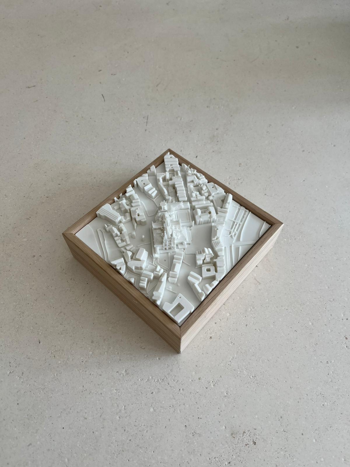 3D city map art in a wooden frame, minimalist decor piece on a light surface