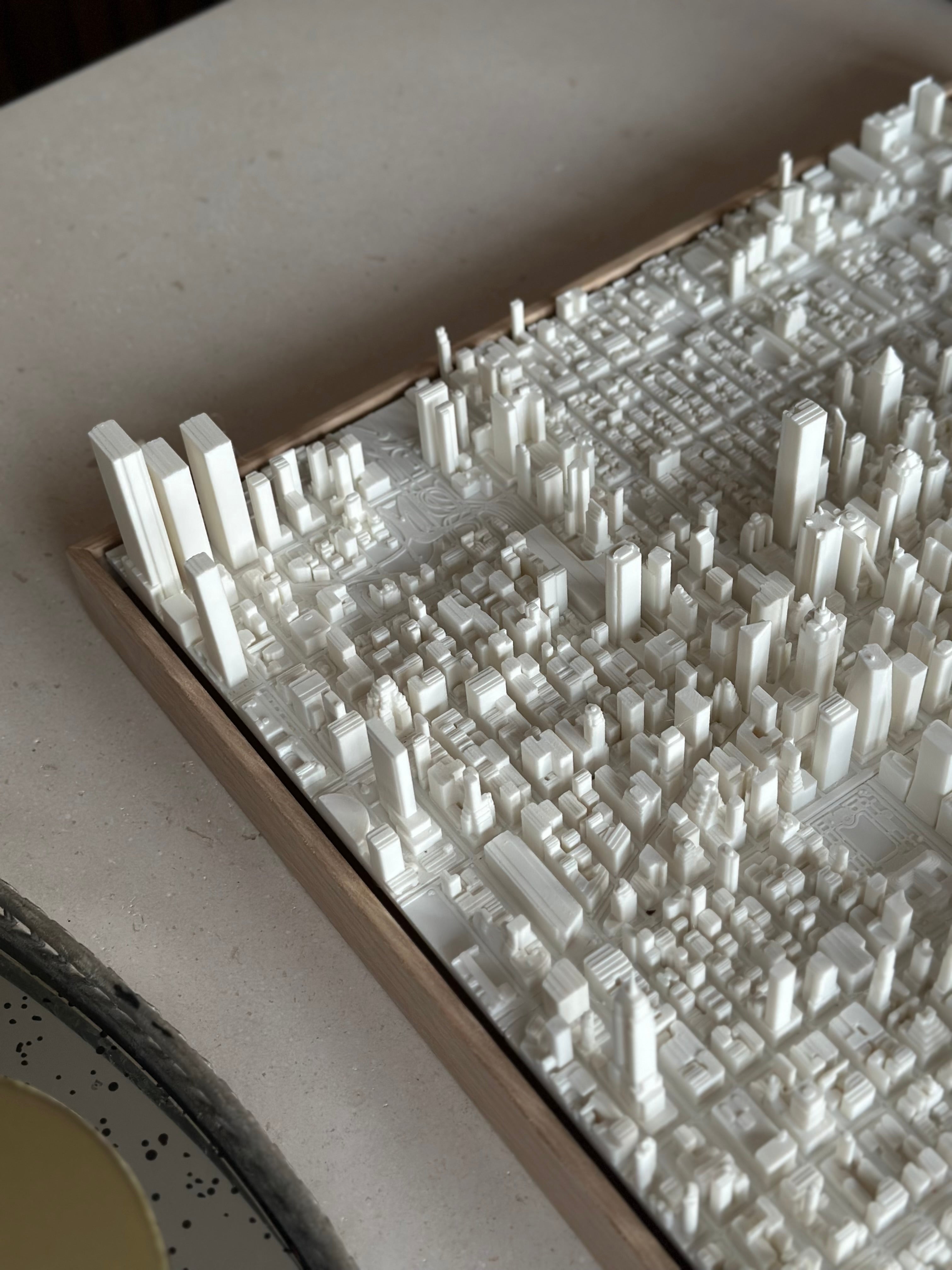 3D city map wall art with detailed white buildings in a wooden frame, modern decor