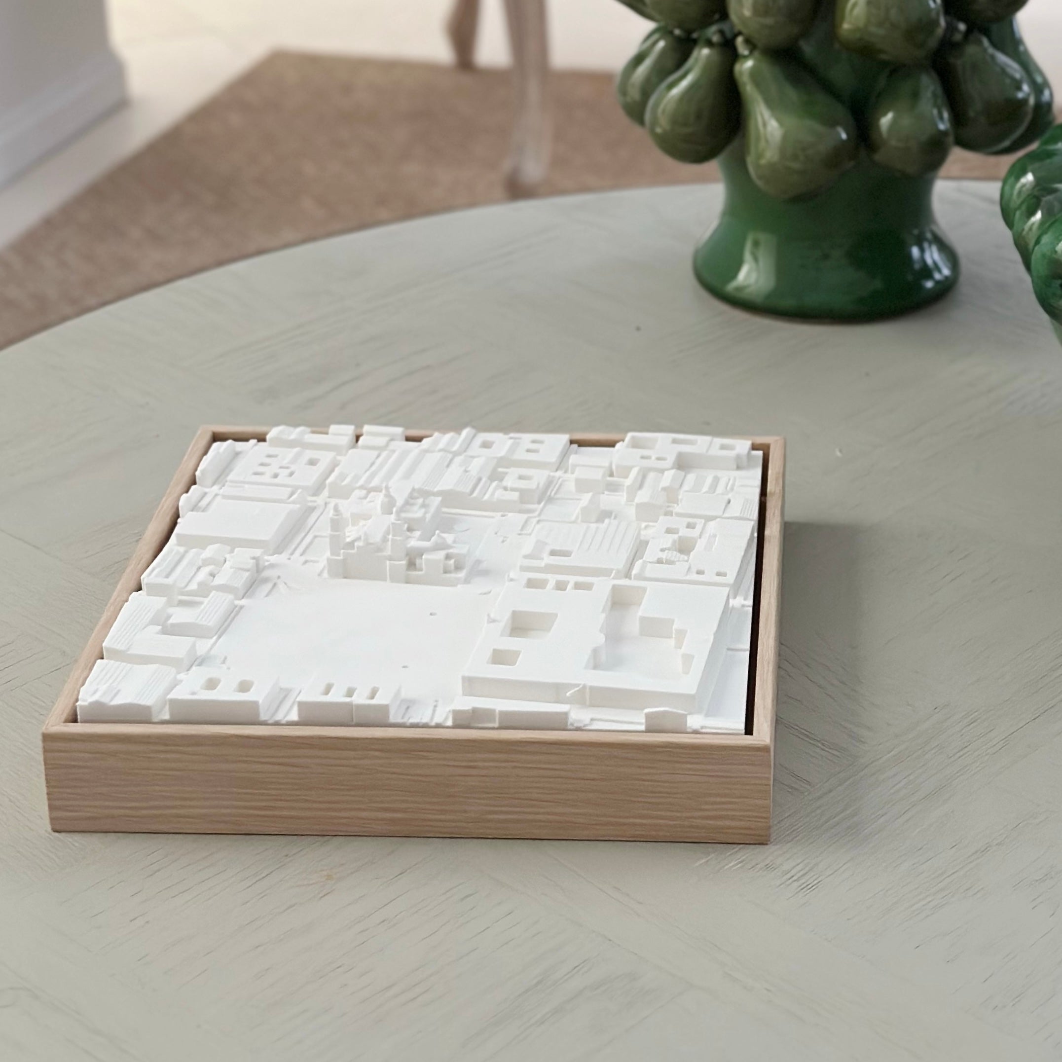 3D city map art in a wooden frame on a light table, modern home decor.