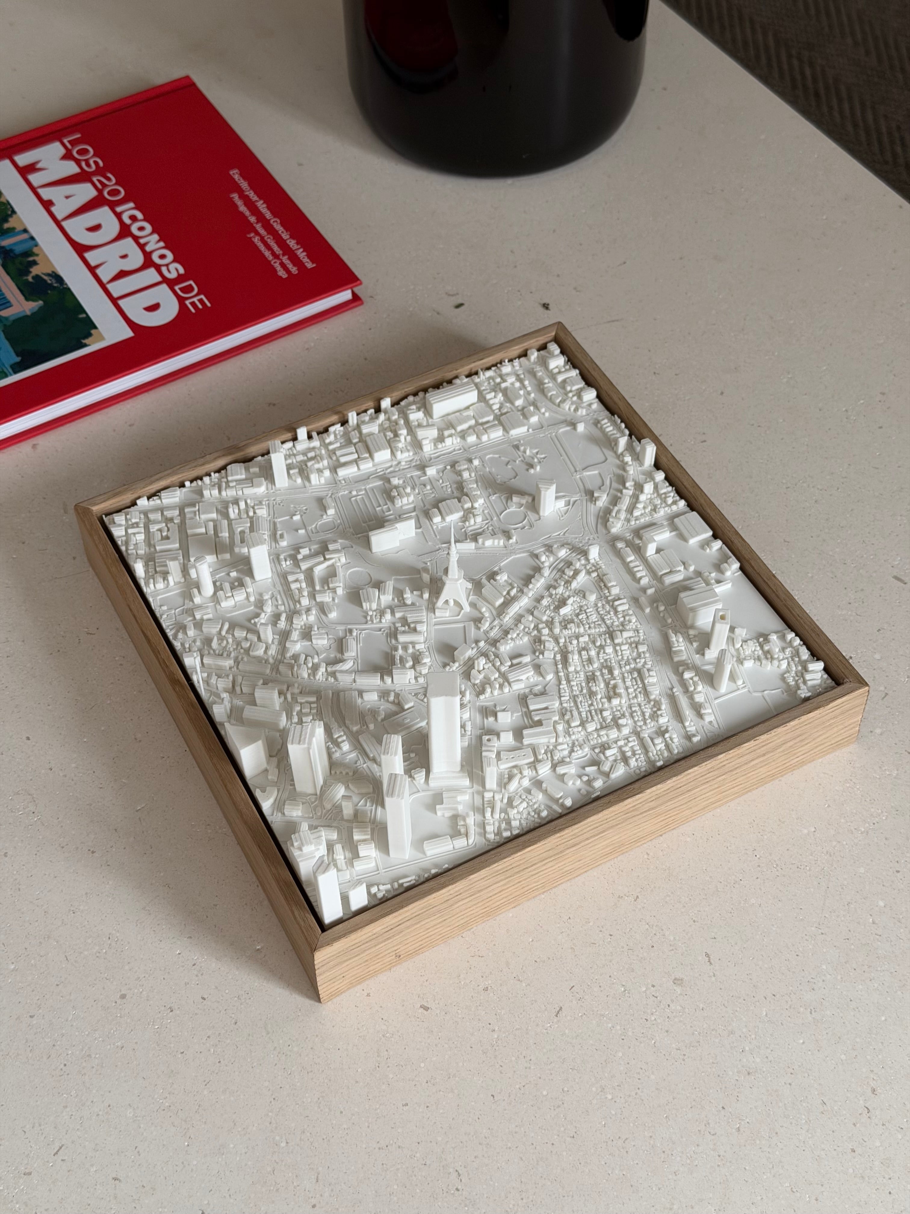 3D Madrid city map art in a wooden frame on a table, modern decorative wall piece