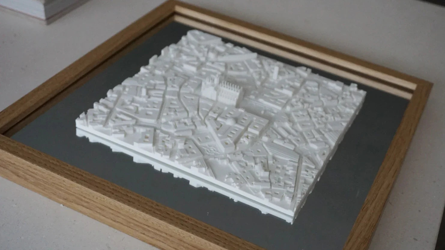 3D city map wall art with white buildings in a wooden frame, modern cityscape decor