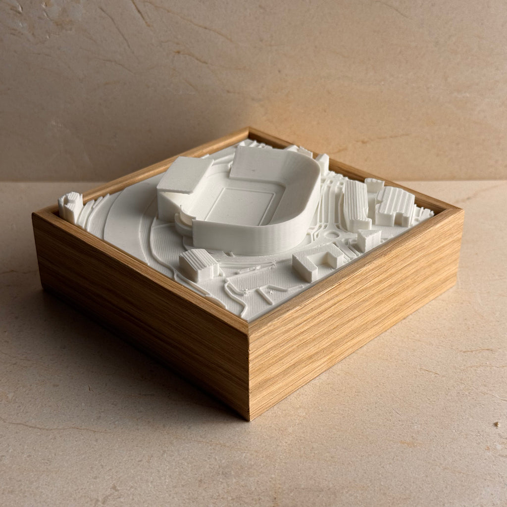 3D city map art in wooden frame featuring a detailed miniature stadium model