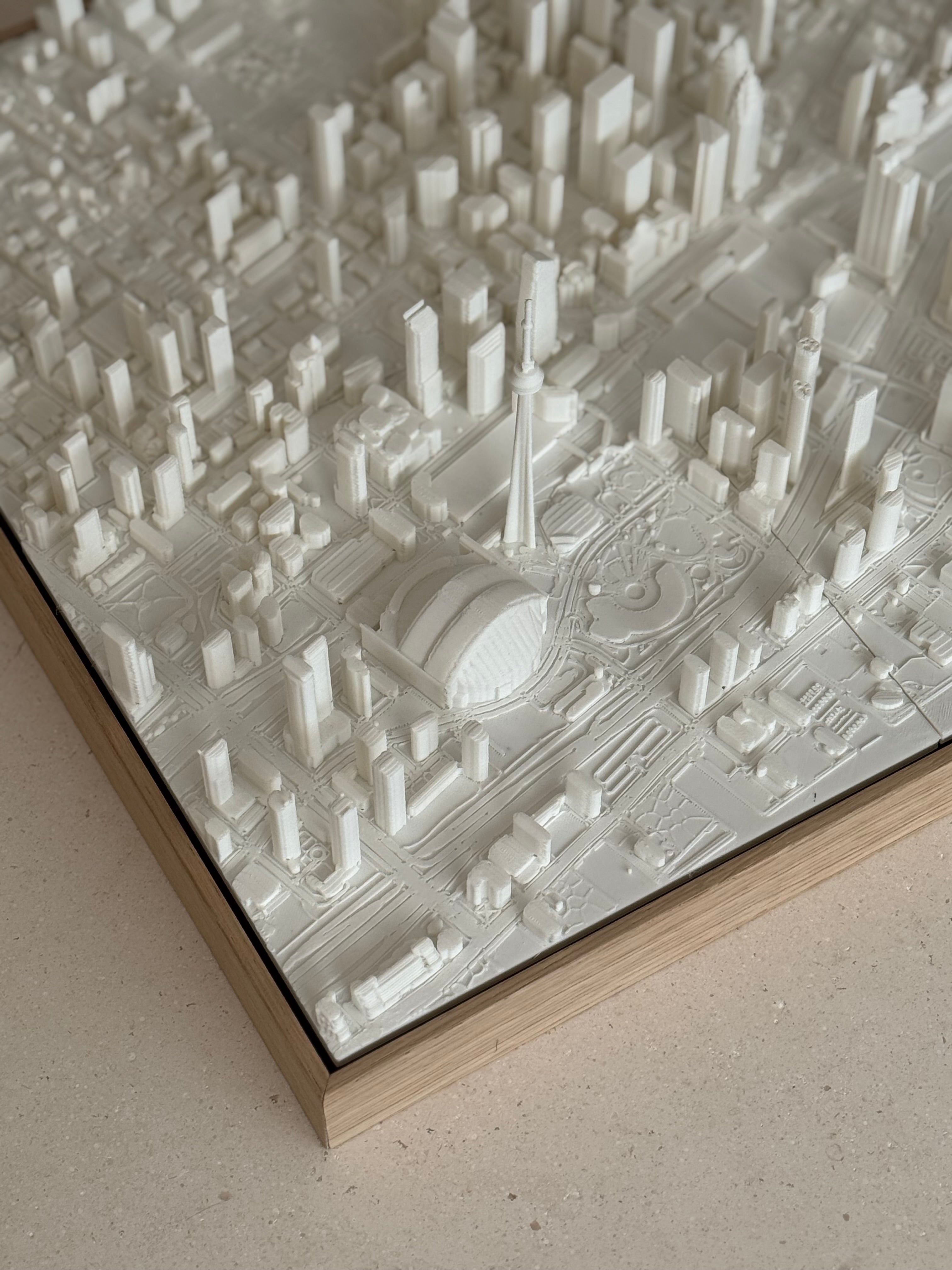 3D city map wall art featuring detailed buildings and landmarks in a white frame