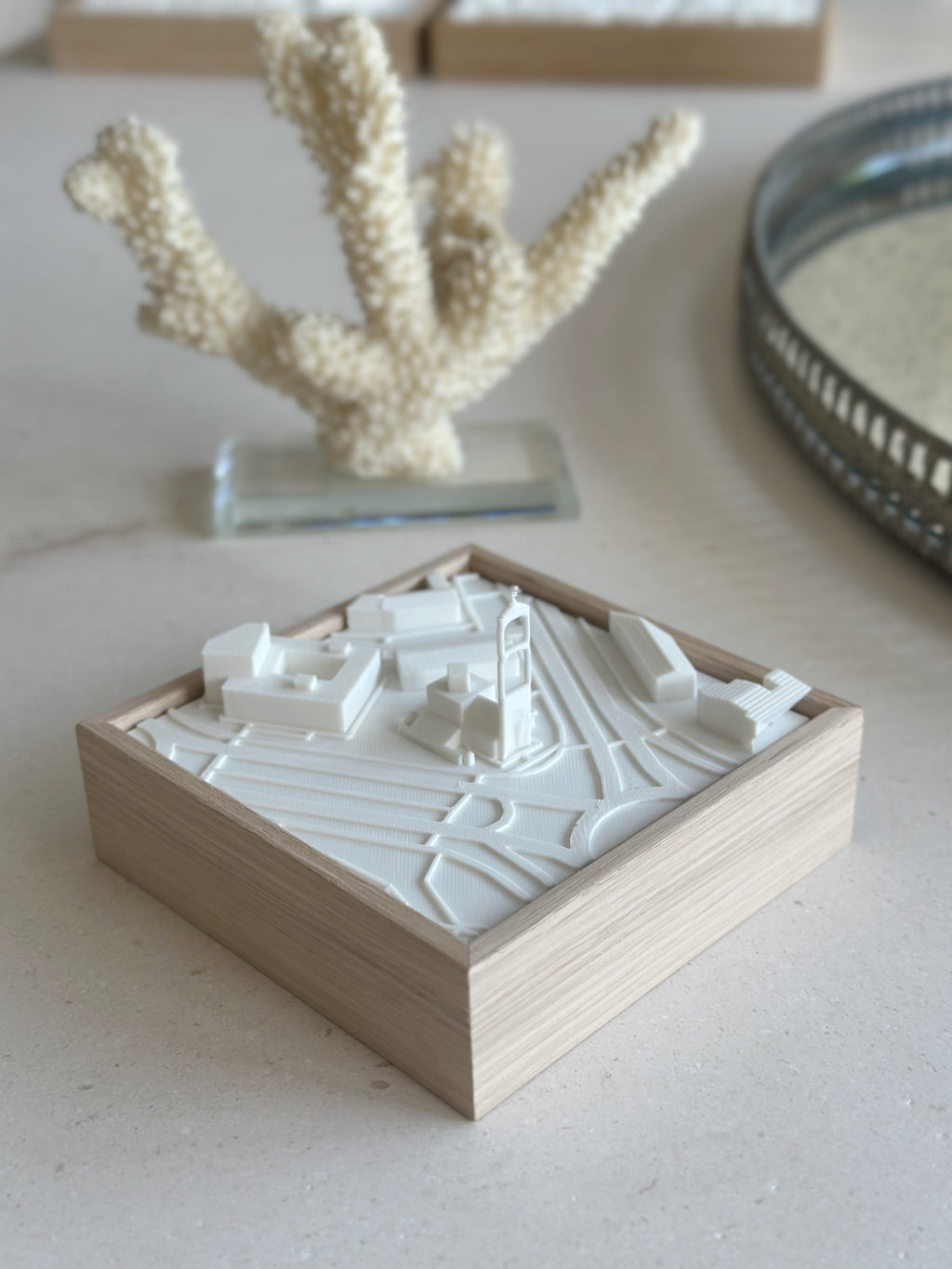 3D city map wall art in a wooden frame, modern minimalist decor on a light surface