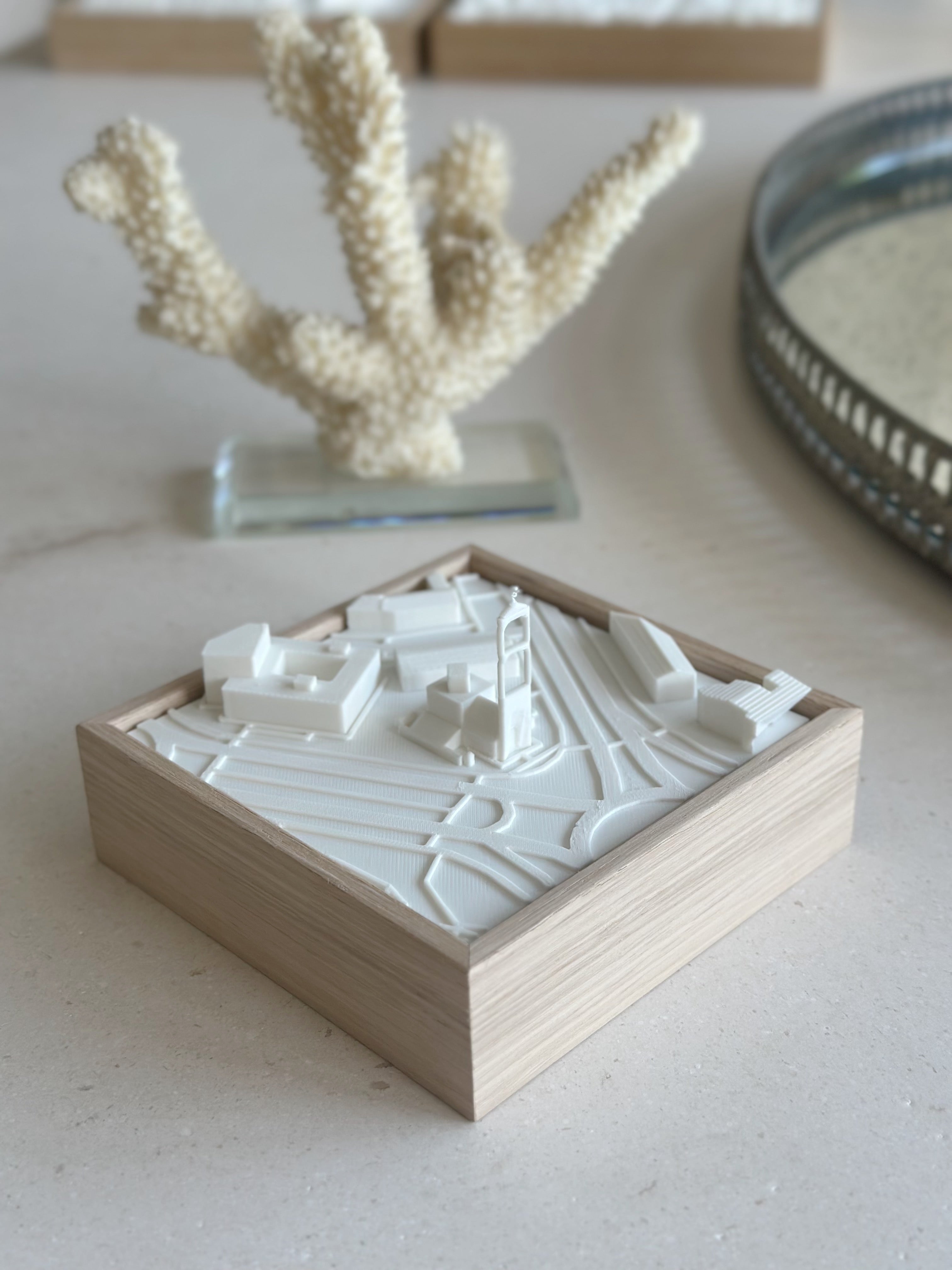 3D city map wall art in a wooden frame, modern minimalist decor on a light surface