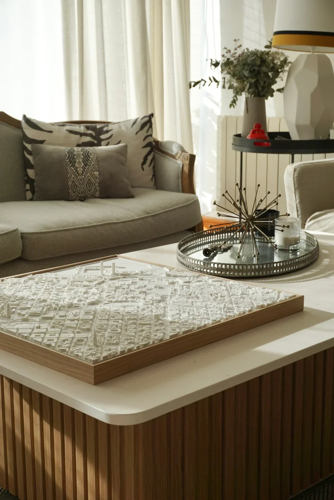 3D city map wall art on modern coffee table in a stylish living room with natural light